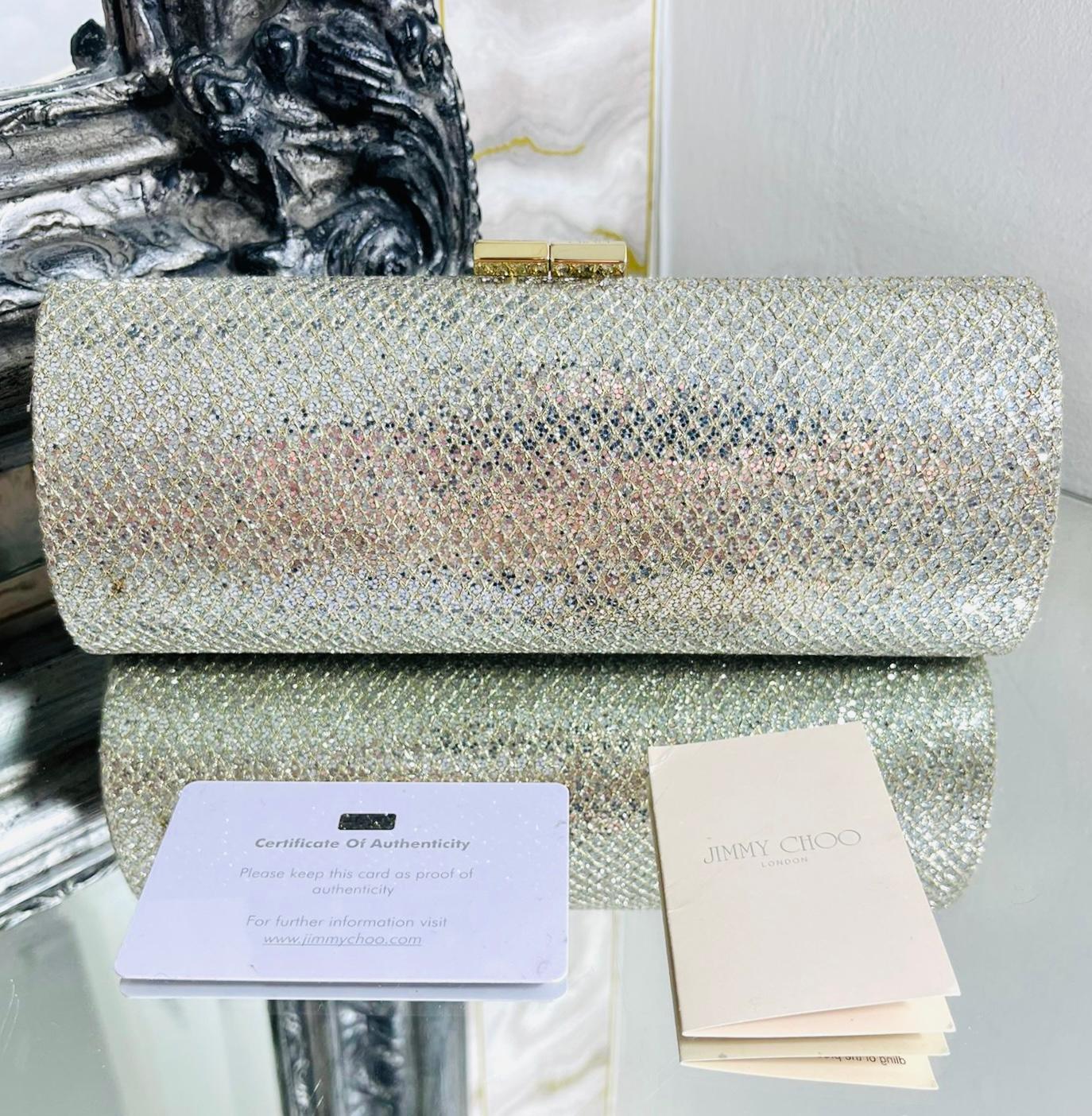 Jimmy Choo Tube Glitter Clutch Bag

Champagne, tube shaped clutch bag designed in silver glitter with gold thread diamond stitching.

Featuring gold hardware and 'Jimmy Choo' logo engraved clasp closure leading to satin lined interior.

Size –