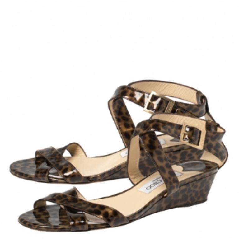 Frolic in comfort with these sandals from Jimmy Choo. They carry a simple design of leopard-printed patent leather straps and a set of comfortable wedge heels. They'll keep you at ease and look amazing on your feet.