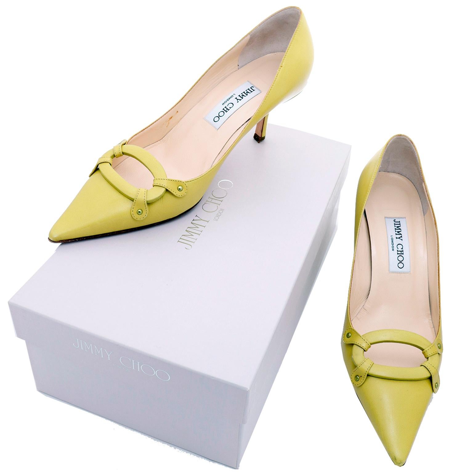 These vintage Jimmy Choo shoes are in a bright chartreuse green leather and have open leather buckles attached with 4 leather riveted straps on the toe box. The shoes come with their original box and dust bag and are labeled Lime 1727 Kid size 37.