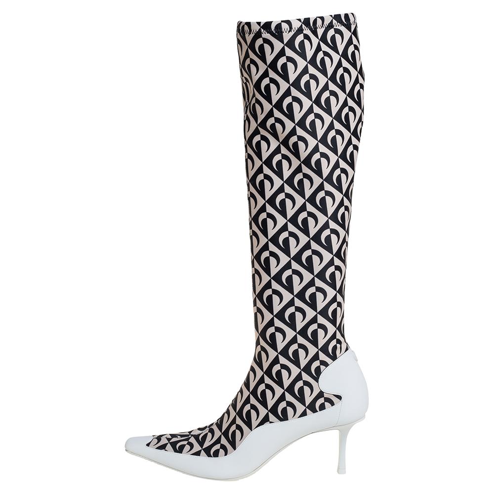 In a unique collaboration with Marine Serre, Jimmy Choo brings you these stunning knee-high boots. Crafted from leather and stretch fabric into a pointed-toe silhouette, these boots are adorned with Marine Serre's signature crescent print in black