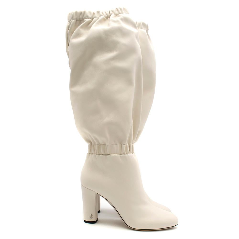 Jimmy Choo latte white Maxyn 85 boots in soft nappa leather featuring an elasticated opening, almond toe, a mid high block heel and a slip-on style. 

Composition:
Composition
Lining: 
- 100% goat skin
Outer: 
- 100% lamb skin
Sole: 
- 80% calf