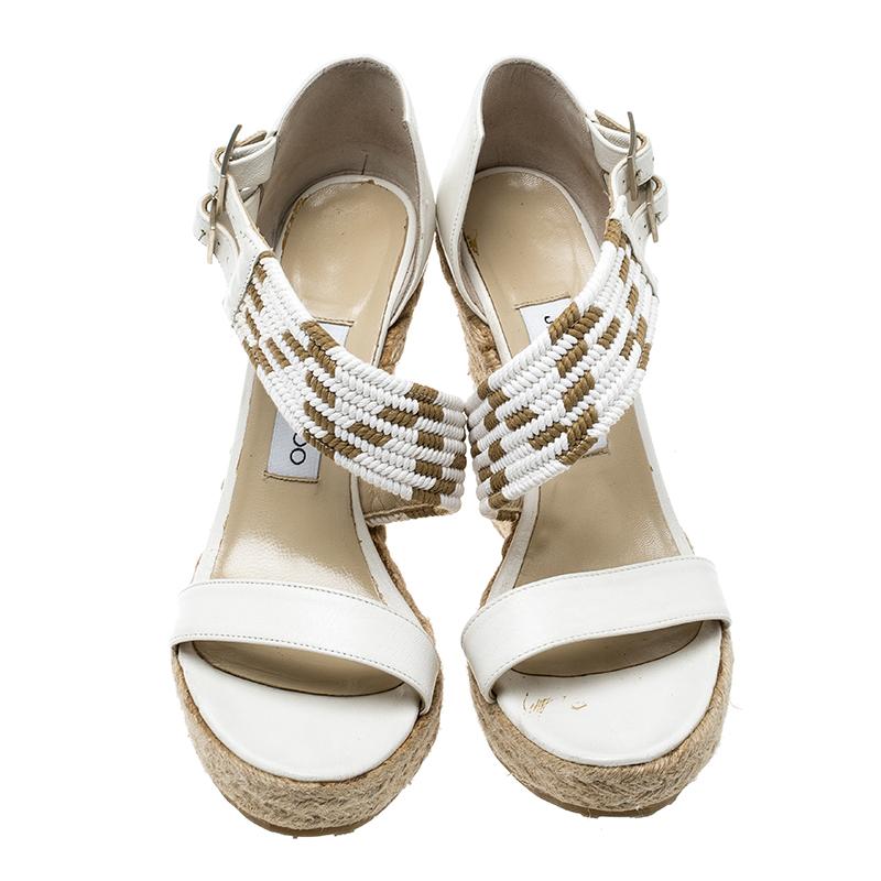 Set on a towering espadrille wedge heel, this Jimmy Choo pair is sure to win you many compliments. It features a white leather woven cross-strap body that is secured with two buckle closure. Wear with an all-white ensemble for a polished
