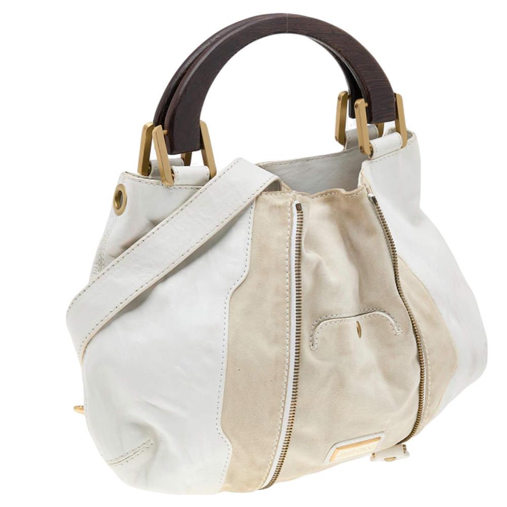 Carry this opulent and chic Maia Hobo coming from Jimmy Choo to adorn your outfit. Crafted from suede and leather, it features impressive wooden handles and a detachable shoulder strap. This hobo profiles an attractive center zipper that makes it
