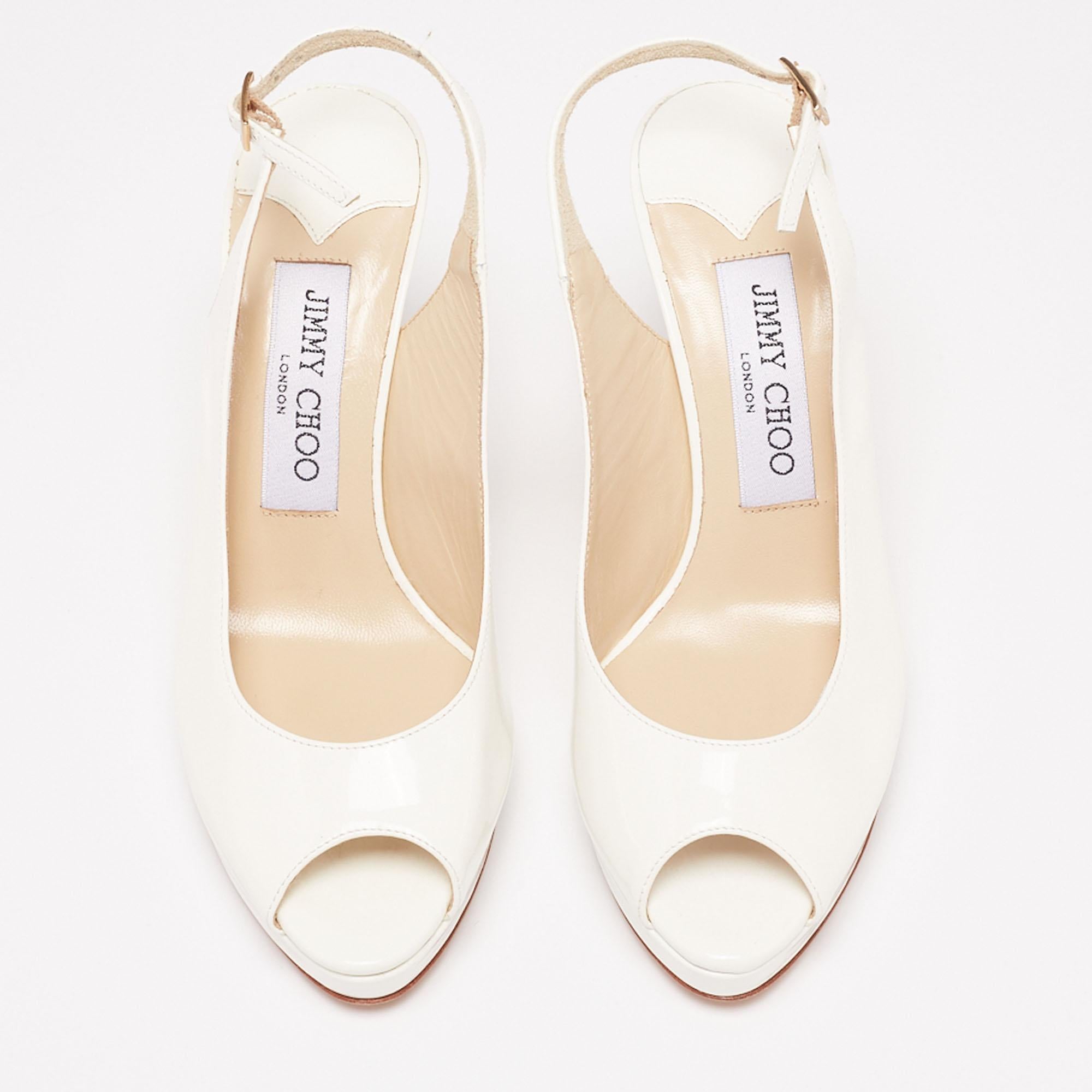 Take every step with confidence and elegance in these sandals from the House of Jimmy Choo. They are crafted using white patent leather and flaunt peep-toes, a slingback, and pointy heels. These sandals are adorned with gold-tone