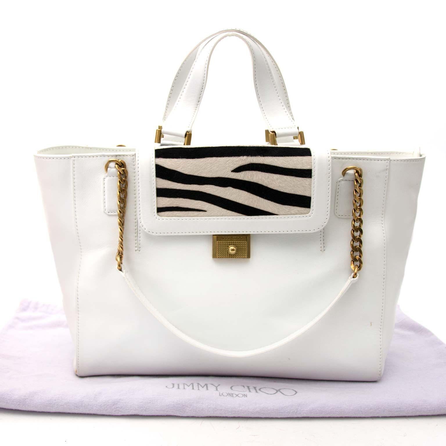 Preloved condition

Jimmy Choo White Tote bag with Zebra Pattern Flap

This tote bag is perfect for a summer shopping trip. The zebra pattern is made out of ponyhair. 
The inside of the bag is made out of  light brown suede. Top and shoulder handels