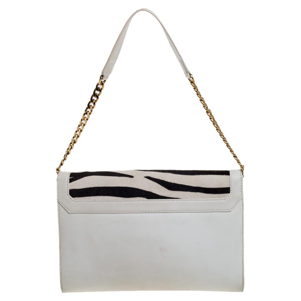 Carry your essentials in this distinctively stylized bag from Jimmy Choo. Its exterior is crafted from calf hair with zebra print, which is in perfect sync with white leather and gold-tone hardware. It features a single handle and a flap closure.