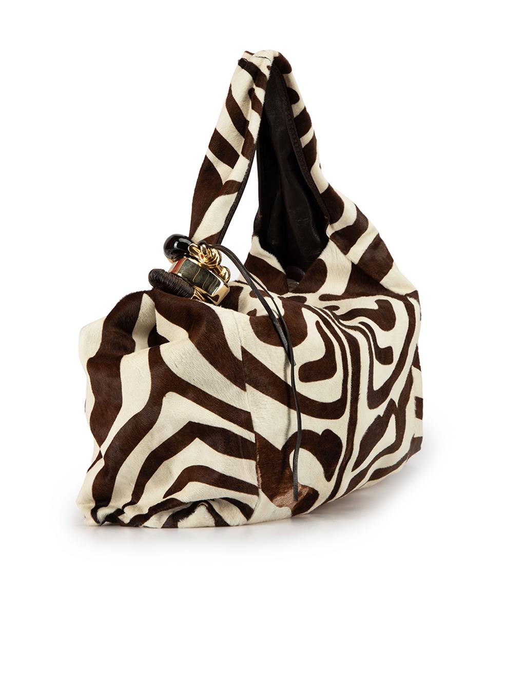 CONDITION is Very good. Minimal wear to bag is evident. Minimal wear to the front and back with wearing to the ponyhair texture, the lining has marks to the suede and there is cracking to the trim of the right-side of the top handle on this used