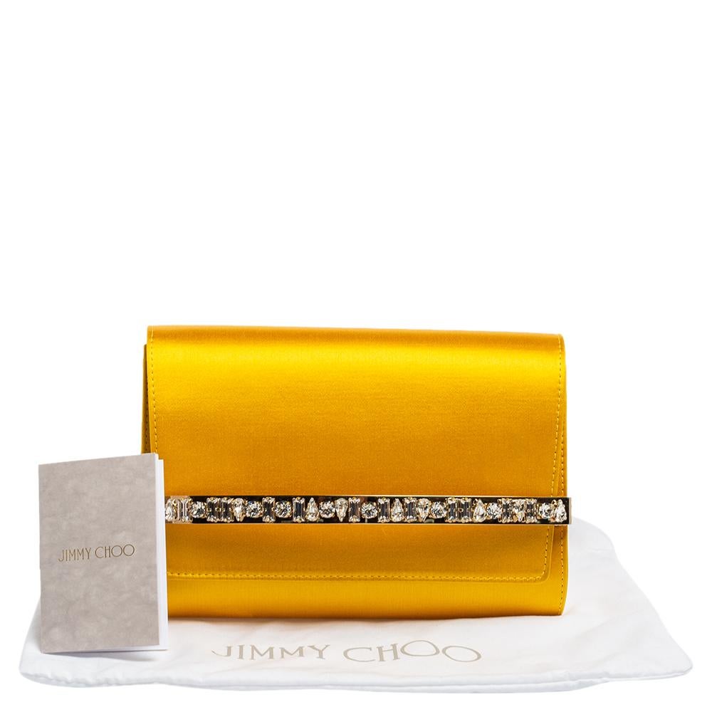 The House of Jimmy Choo brings you yet another gorgeous accessory with this clutch. It is made from yellow satin, which is elevated with delicate crystal embellishments. It has a sturdy silhouette that encloses an organized leather-lined interior.