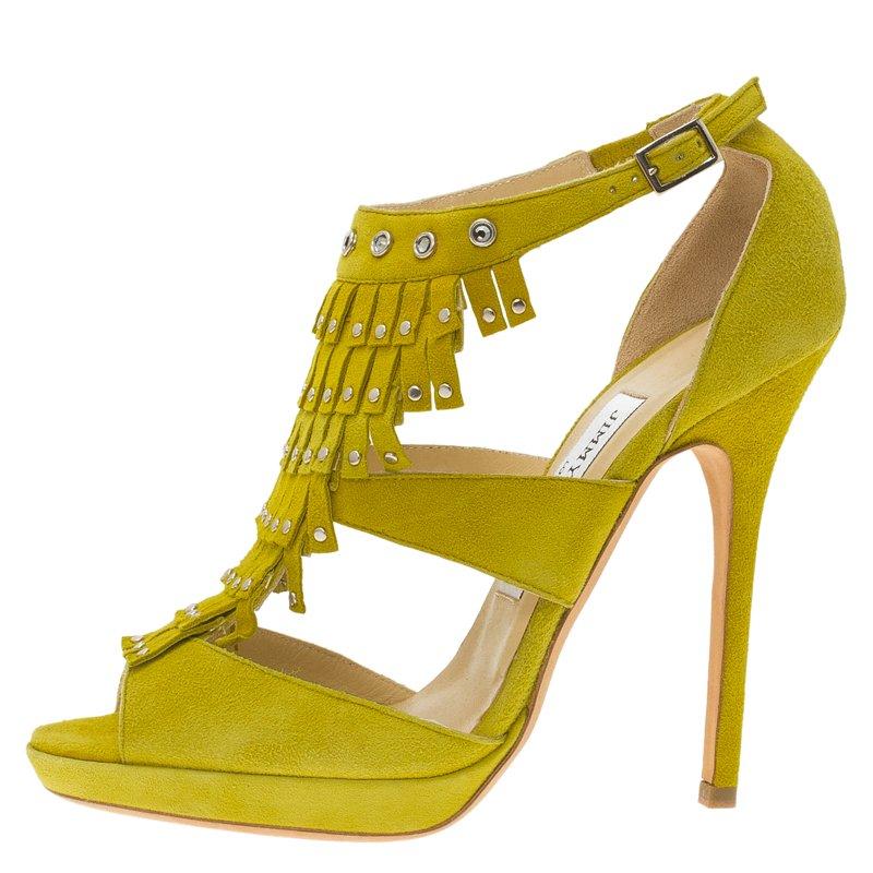 The stunning stilettos from Jimmy Choo are the emblematic essence of femininity at its finest. These sensual yellow suede leather pumps flaunt the swinging fringes at the front and are elegantly embellished with silver studs on the fringes and