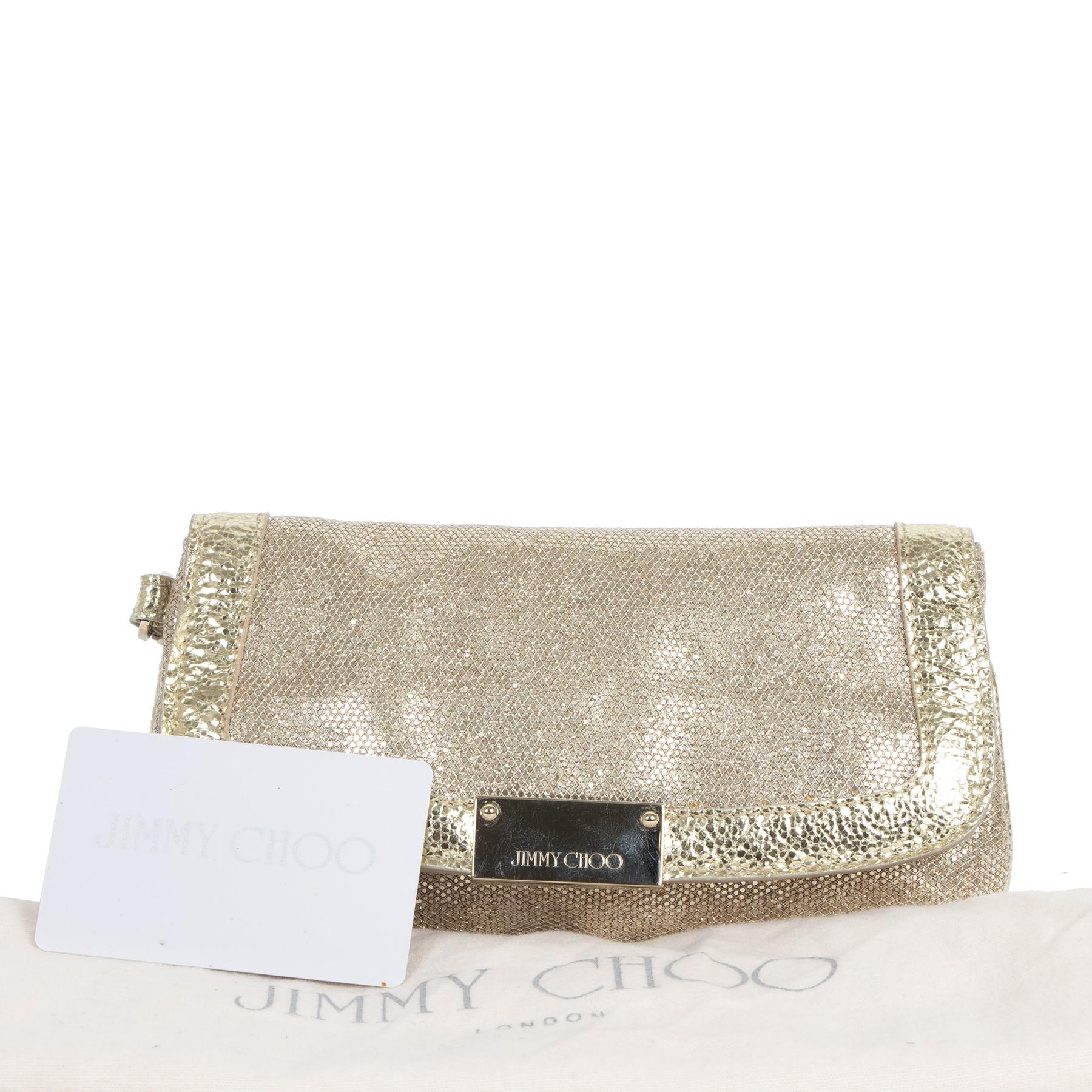Very good condition

Jimmy Choo Zeta Gold Glitter Clutch

Turn every look into a festive ensemble with this gorgeous Jimmy Choo Zeta Clutch. This bag comes just in time for the most sparkly period of the year and is perfect for the holidays. It's