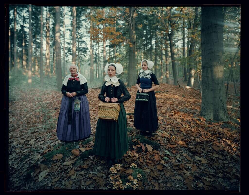 NL-ZEE-AXE-A09  Veluwe - Gelderland, Niederlande, 2024  Alie, Nienke & Rhodé

Der eigentliche Zweck dieses traditionellen Kleides war es, zu zeigen, dass sich die Trägerin diesen unpraktischen Stil leisten konnte. Auch ihre Ringe - breite Bänder,