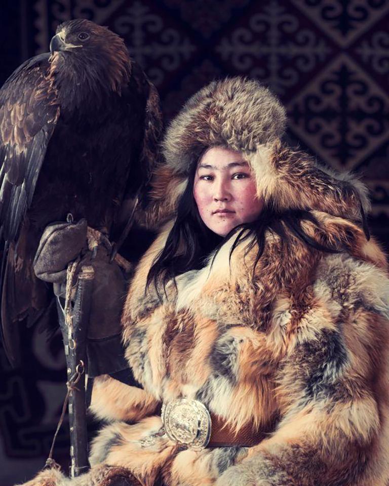 "XXX 10
Janerk Haizim Eagle Huntress
Sagsai, Bayan Ulgii Province, 
Mongolia 2017

The Mongolian Kazakhs travelled through Russia to the Mongolian Altai Mountains living as semi-nomads, moving several times a year according to the season. The