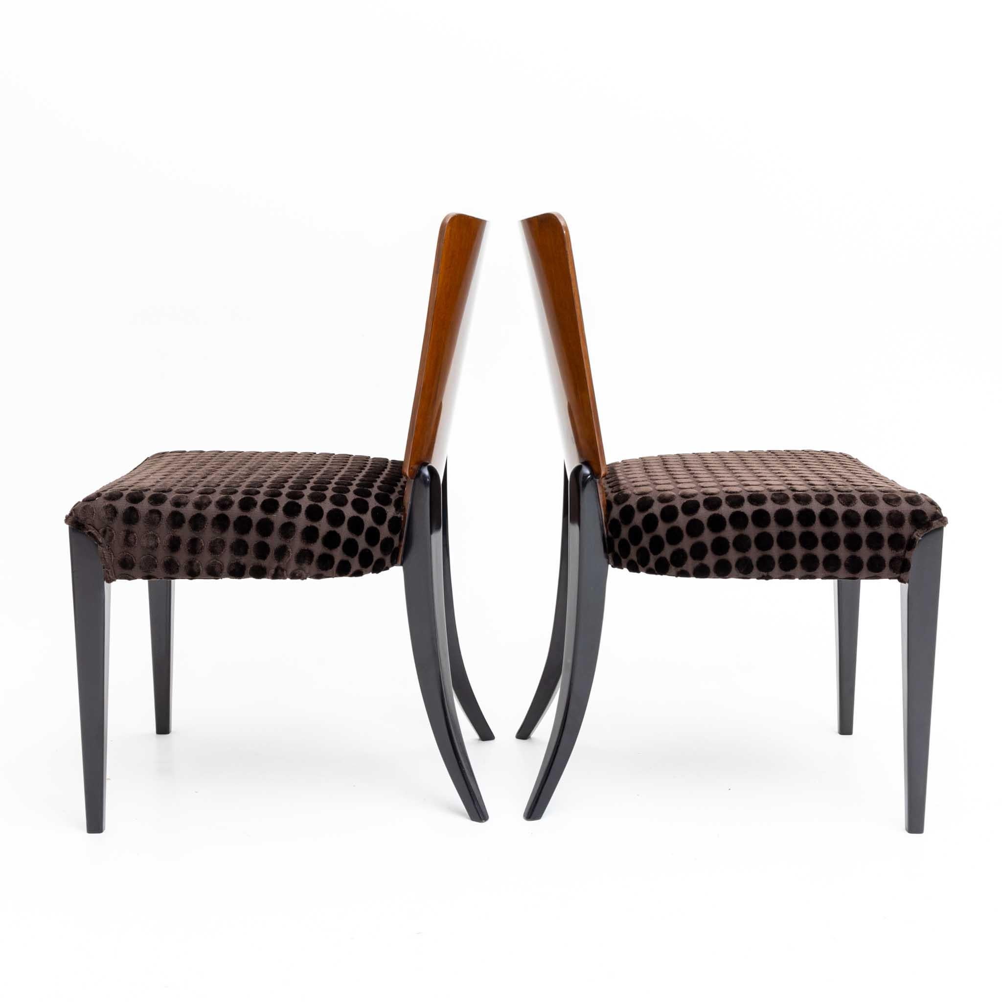 Eight chairs by Jindrich Halabala with ebonised legs and trapezoidal backrest. The chairs are restored and in very good condition.