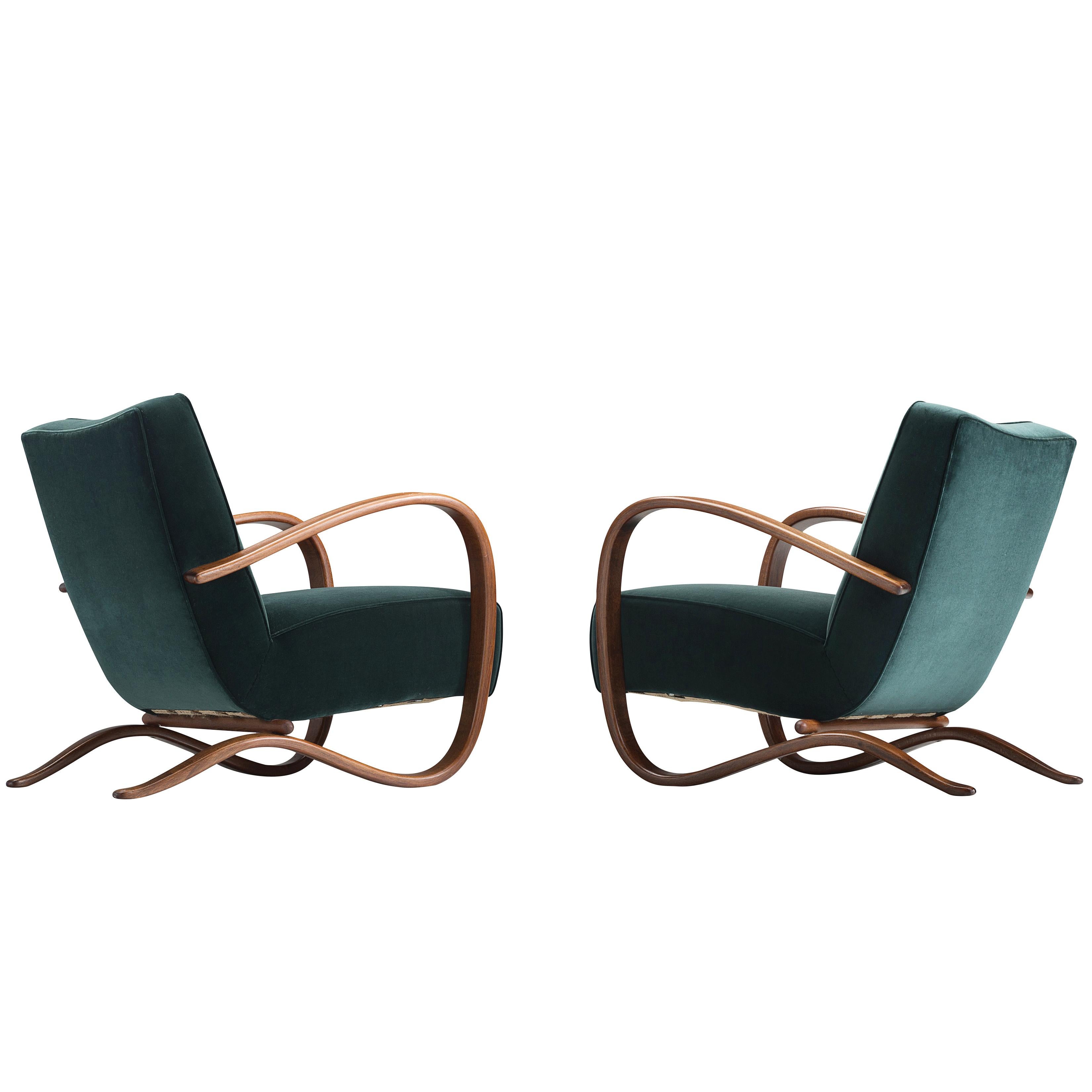 Jindrich Halabala, customizable lounge chair, wood, fabric, Czech Republic, 1930s 

Extraordinary easy chair in green velvet upholstery. This chair has a very dynamic and abundant appearance. Beautifully curved armrests in a brown color add a