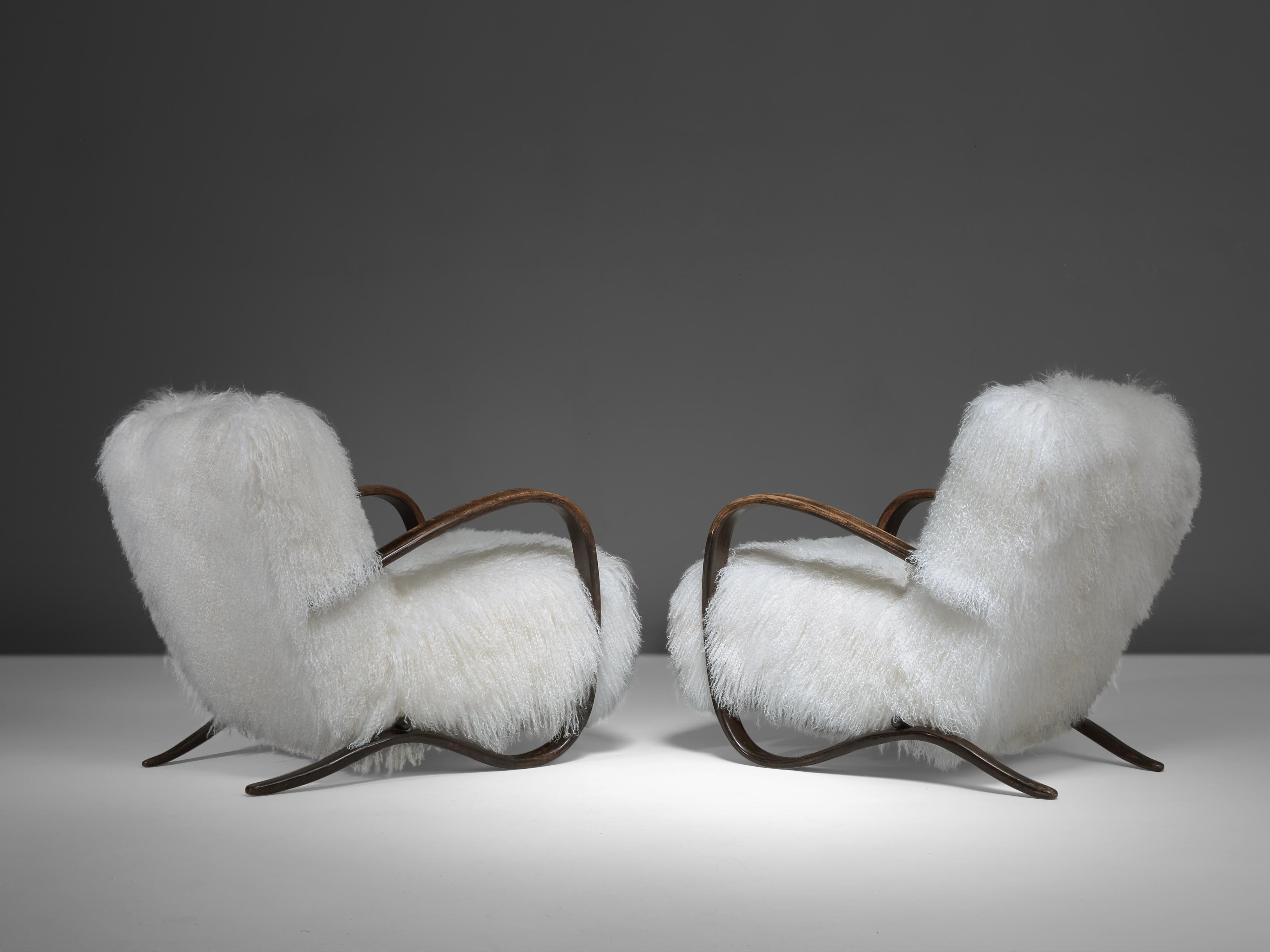 Jindrich Halabala, customizable lounge chairs, beech, Tibetan wool, Czech Republic, 1930s

Extraordinary easy chairs with white Tibetan lamb’s wool upholstery. These chairs have a very dynamic and abundant appearance and the fuzzy upholstery gives