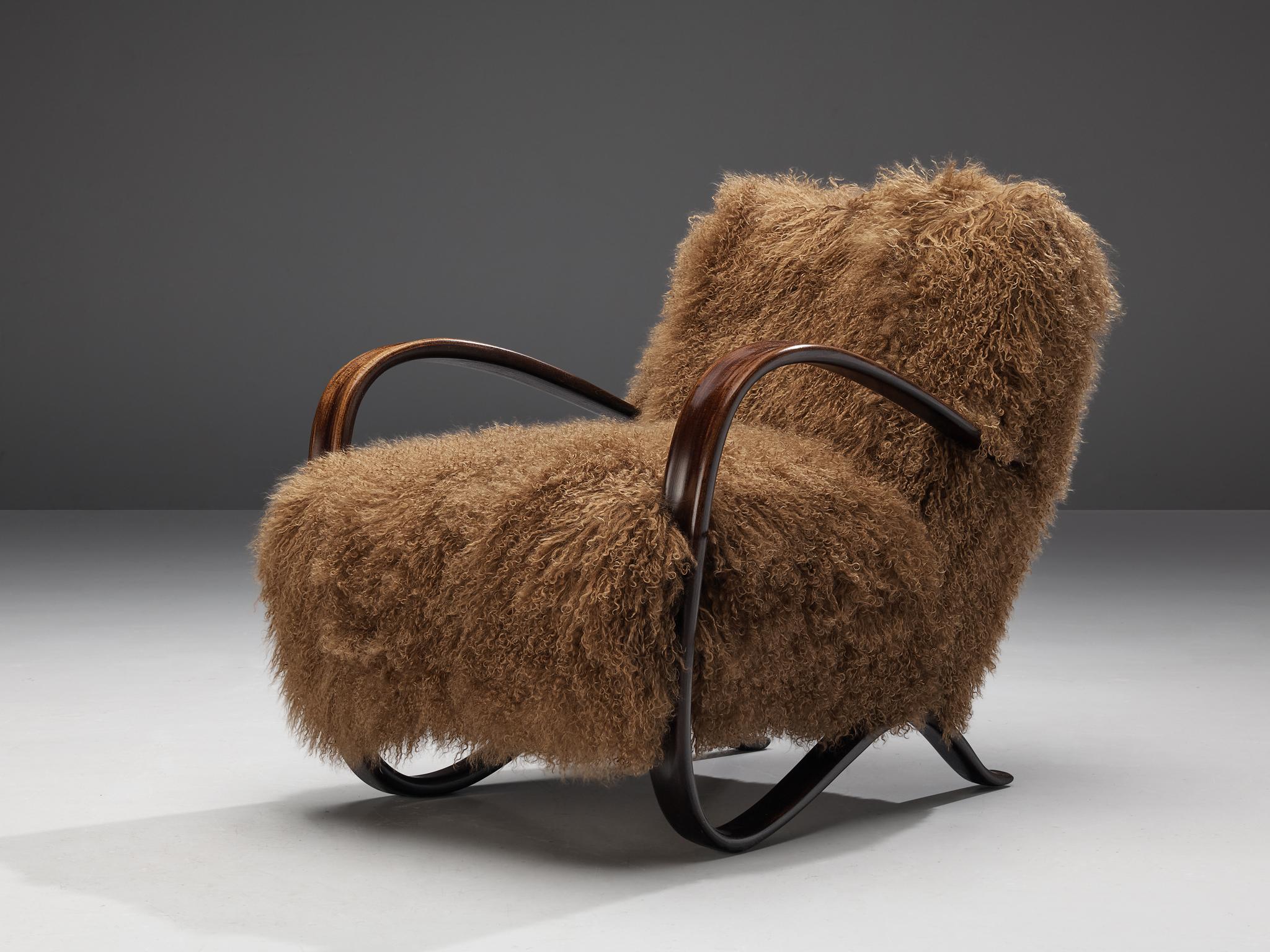 Jindrich Halabala, customizable lounge chairs, stained beech, Tibetan wool, Czech Republic, 1930s

Extraordinary easy chairs with brown Tibetan lamb’s wool upholstery. These chairs have a very dynamic and abundant appearance and the fuzzy upholstery