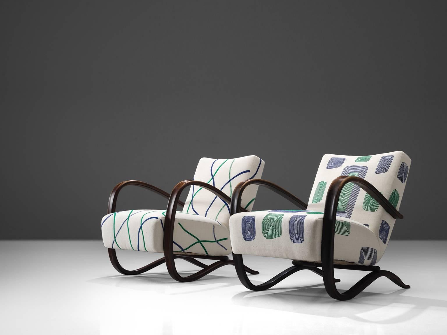 Jindrich Halabala, lounge chairs, graphical white and green fabric and stained beech, Czech Republic, 1930s. 

This extraordinary pair of Halabala chairs is has been upholstered in collaboration with the Jupe by Jackie Home collection. The chair is