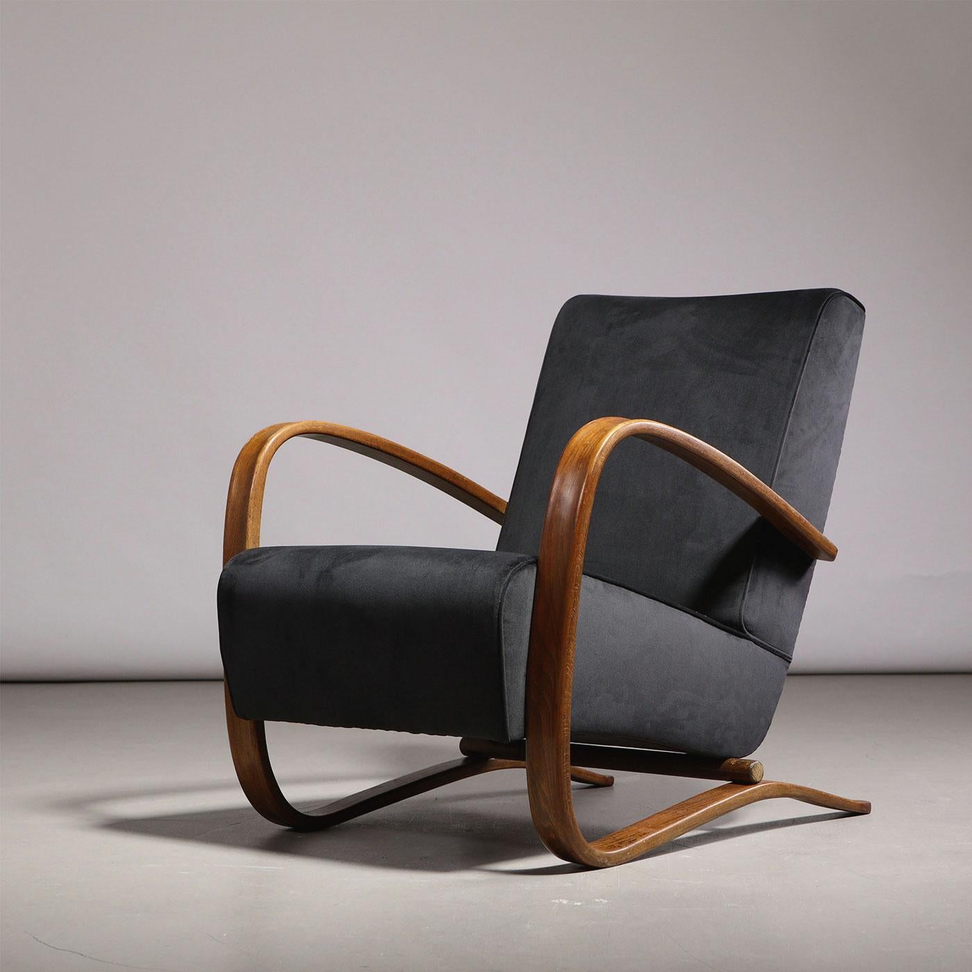 Jindřich Halabala for UP Závody, armchair model ‘H-269’, wood, black velvet fabric upholstery, former Czechoslovakia, 1930s.

One of the best-known armchair models by the renowned Czech designer, the ‘H-269’ model designed for UP Závody features a