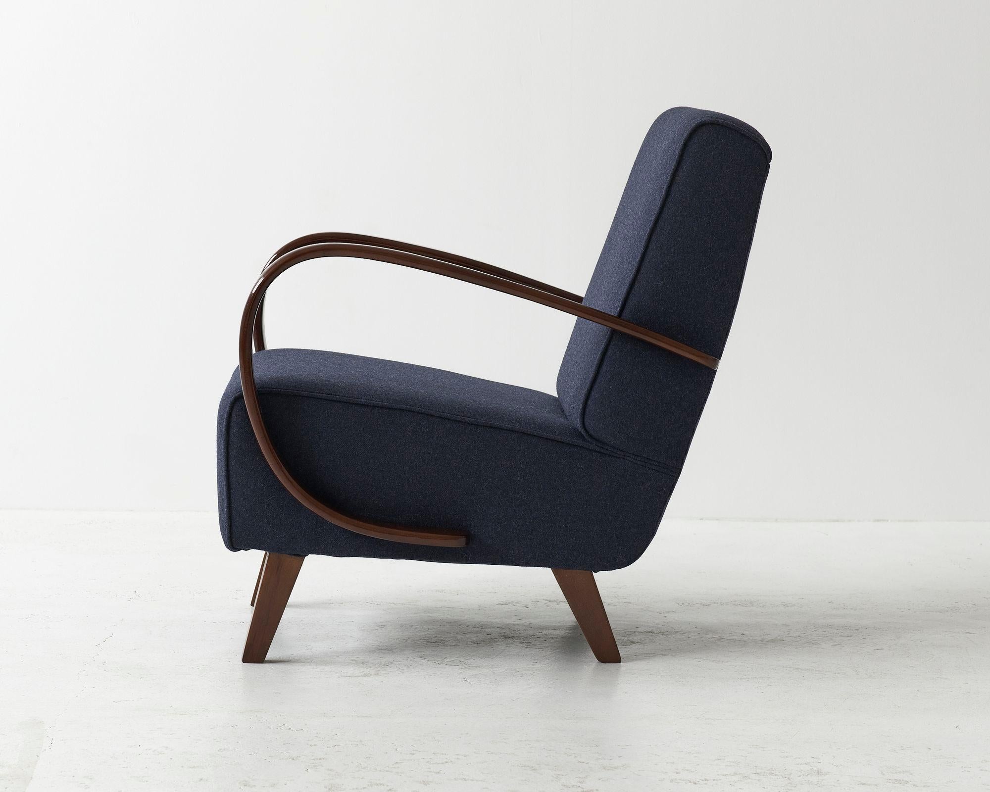 Model H-410 armchair designed by the great czech designer Jindřich Halabala. Striking bentwood armrests. Produced during the 1930's in former Czechoslovakia. Armrestes cleaned, varnished, lacquered. Seating recreated and covered in high quality