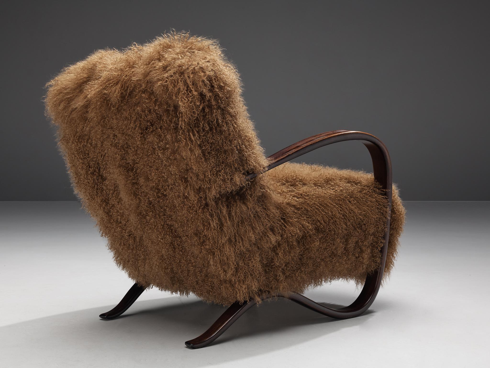 Jindrich Halabala, lounge chair, model 'H269', stained beech, Tibetan lambswool, Czech Republic, 1930s.

Extraordinary easy chair in brown Tibetan lambswool upholstery. This design has a very dynamic and abundant appearance and the fuzzy upholstery