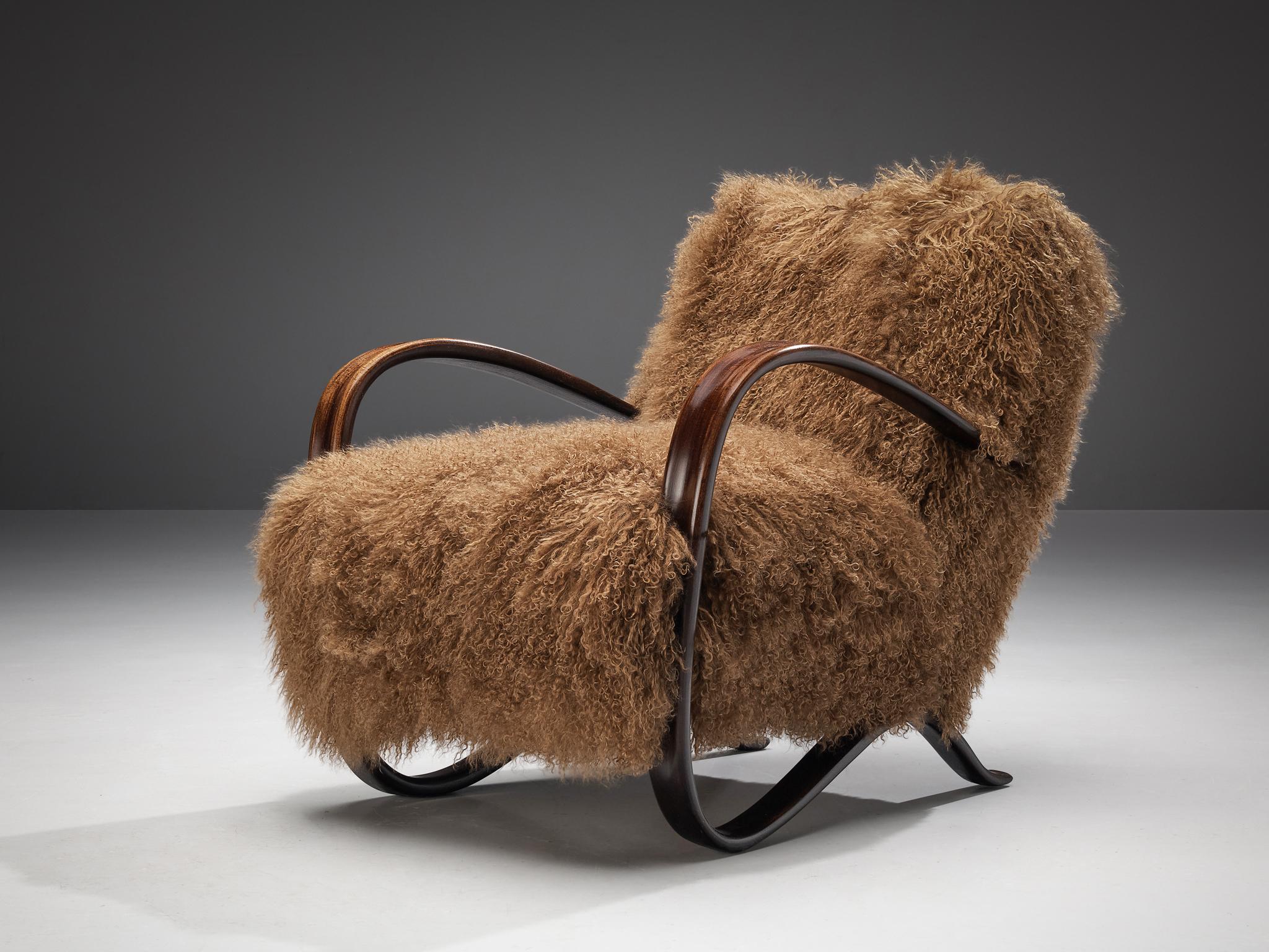 Jindrich Halabala, customizable lounge chair model 'H269', stained beech, Tibetan wool, Czech Republic, 1930s.

Extraordinary easy chair with brown Tibetan lamb’s wool upholstery. This armchair has a very dynamic and abundant appearance and the