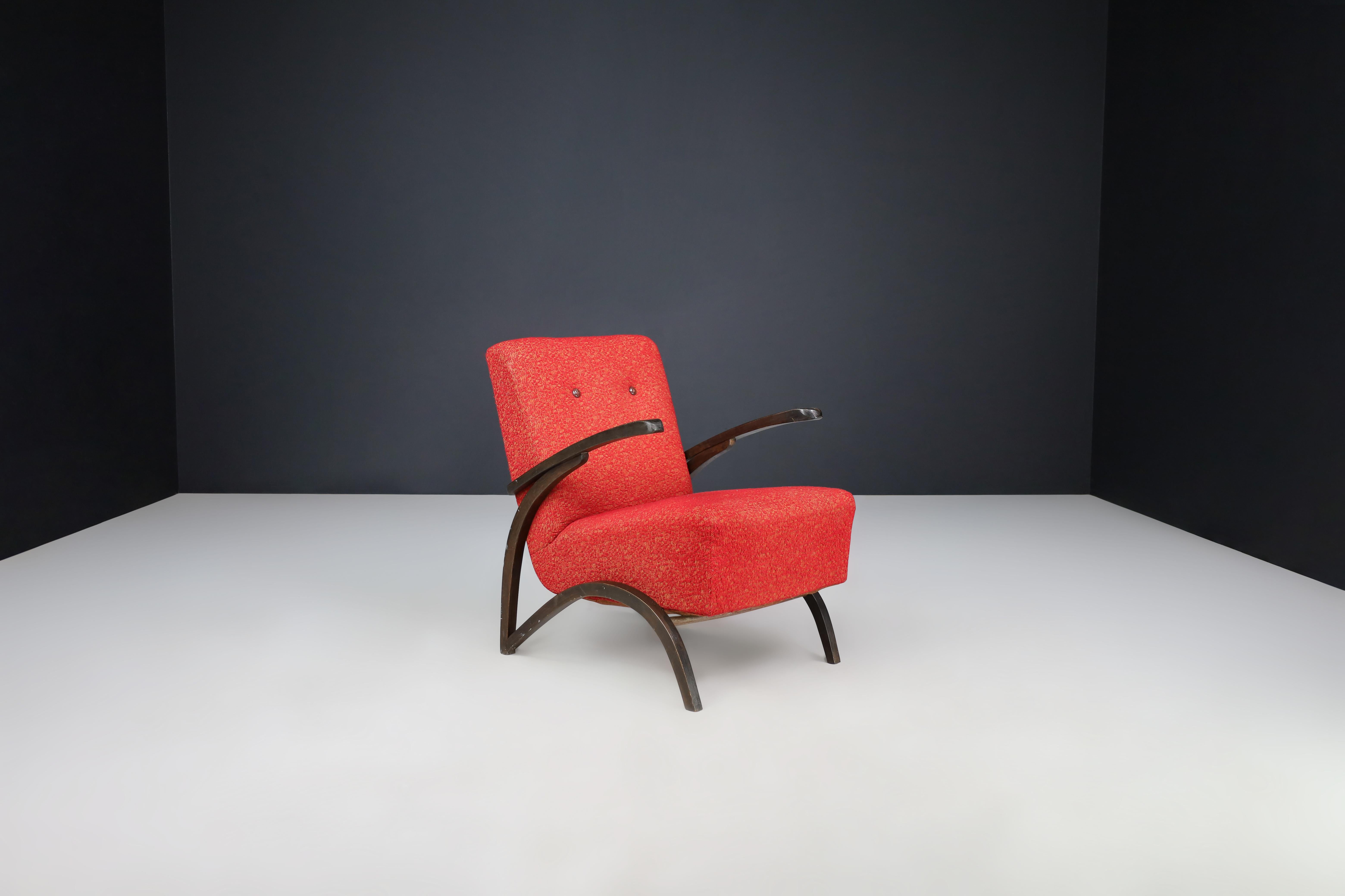 Jindrich Halabala Lounge Chair in Original Red Upholstery Czech Republic 1930.

This elegant lounge chair, designed by Jindrich Halabala and produced by Thonet in Czechia around 1930, is an exemplary representation of the midcentury design in