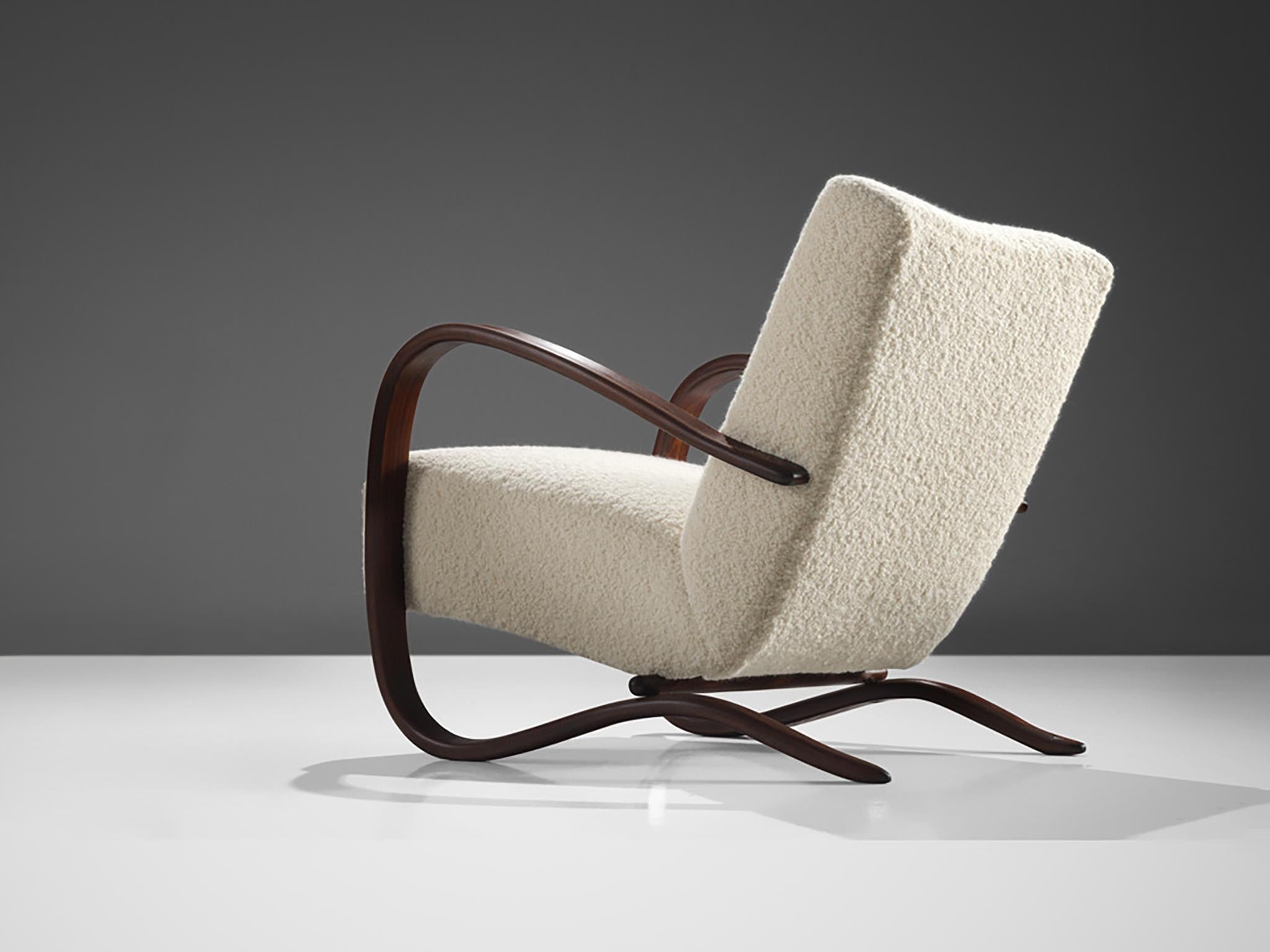 Jindrich Halabala, lounge chair, model 'H269', stained beech, Pierre Frey bouclé, Czech Republic, 1930s.

Extraordinary easy chair upholstered in a fine off-white bouclé by Pierre Frey. This armchair has a very dynamic and abundant appearance and