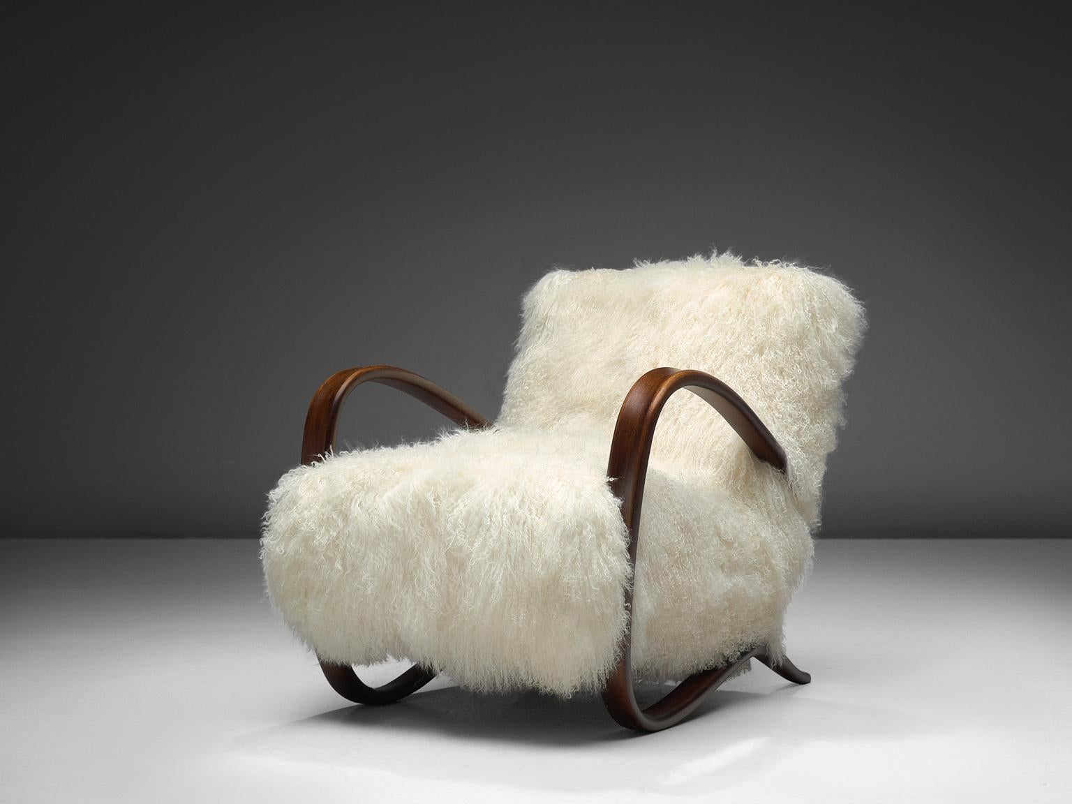 Jindrich Halabala, lounge chair, model 'H269', stained beech, Tibetan lambswool, Czech Republic, 1930s.

Extraordinary easy chair in white Tibetan lambswool upholstery. This design has a very dynamic and abundant appearance and the fuzzy upholstery