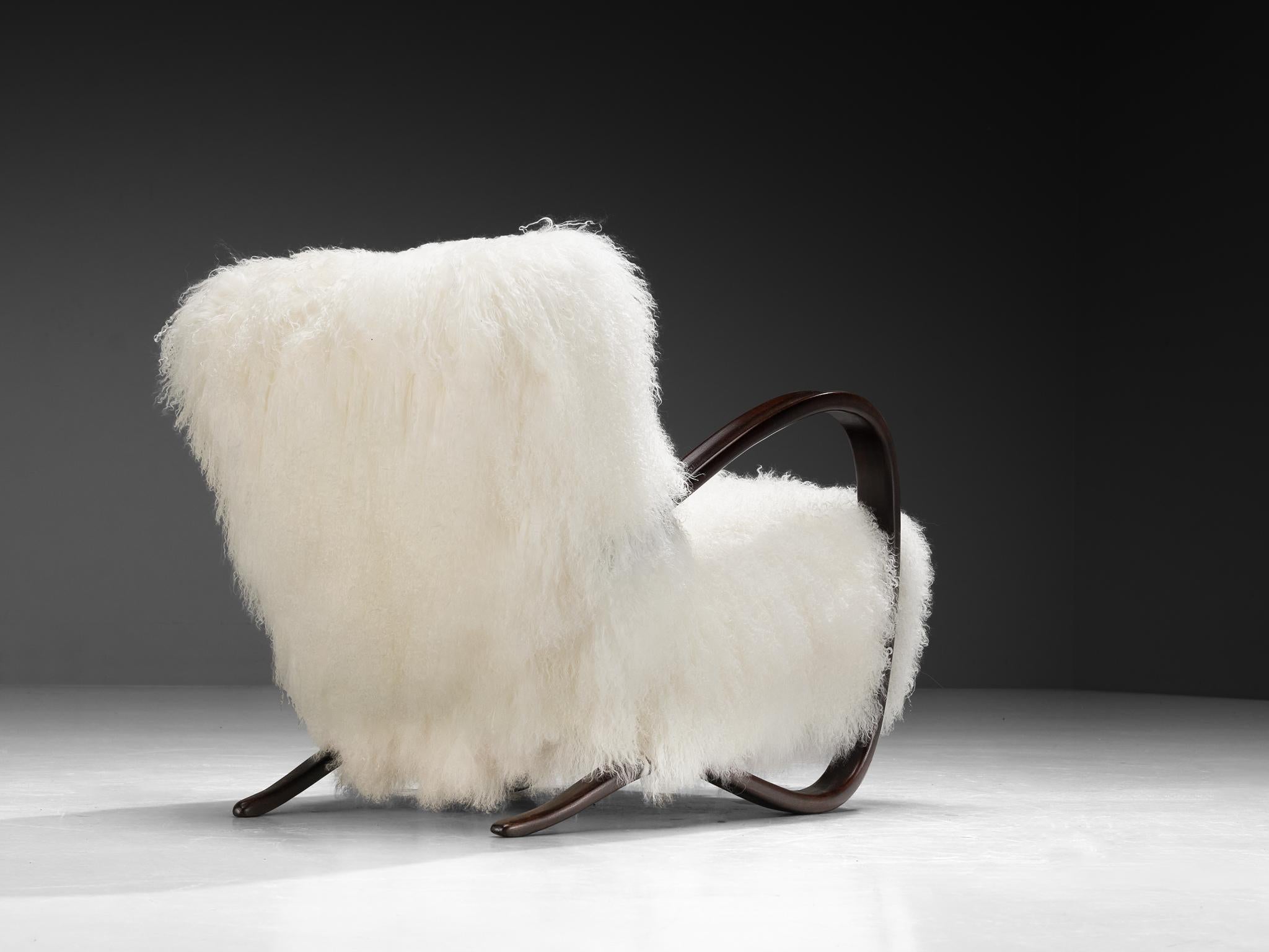 Jindrich Halabala, lounge chair, model 'H269', stained beech, Tibetan lambswool, Czech Republic, 1930s.

Extraordinary easy chair in white Tibetan lambswool upholstery. This design has a very dynamic and abundant appearance and the fuzzy upholstery