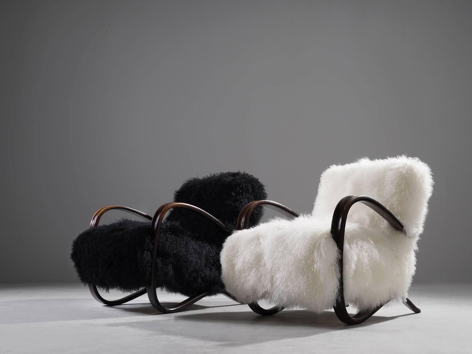 Jindrich Halabala, two lounge chairs, beech and sheepskin, Czech Republic, 1930s. 

This extraordinary pair of Halabala chairs are upholstered with black and white Tibetan lambs wool upholstery in our upholstery studio. These chairs have a very