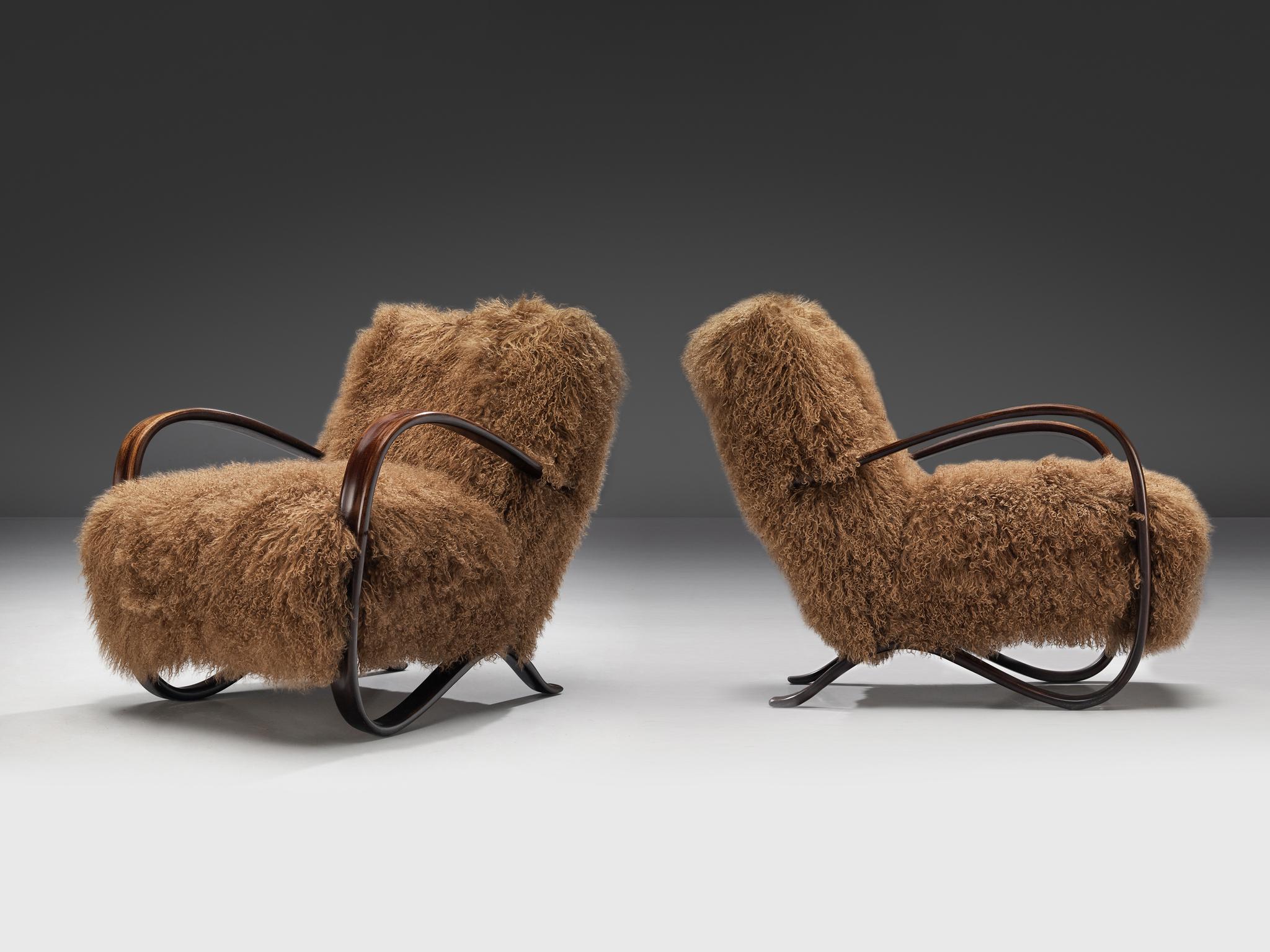 Jindrich Halabala, lounge chairs, model 'H269', beech, Tibetan lambswool, Czech Republic, 1930s.

Extraordinary easy chairs in brown Tibetan lambswool upholstery. These chairs have a very dynamic and abundant appearance and the fuzzy upholstery