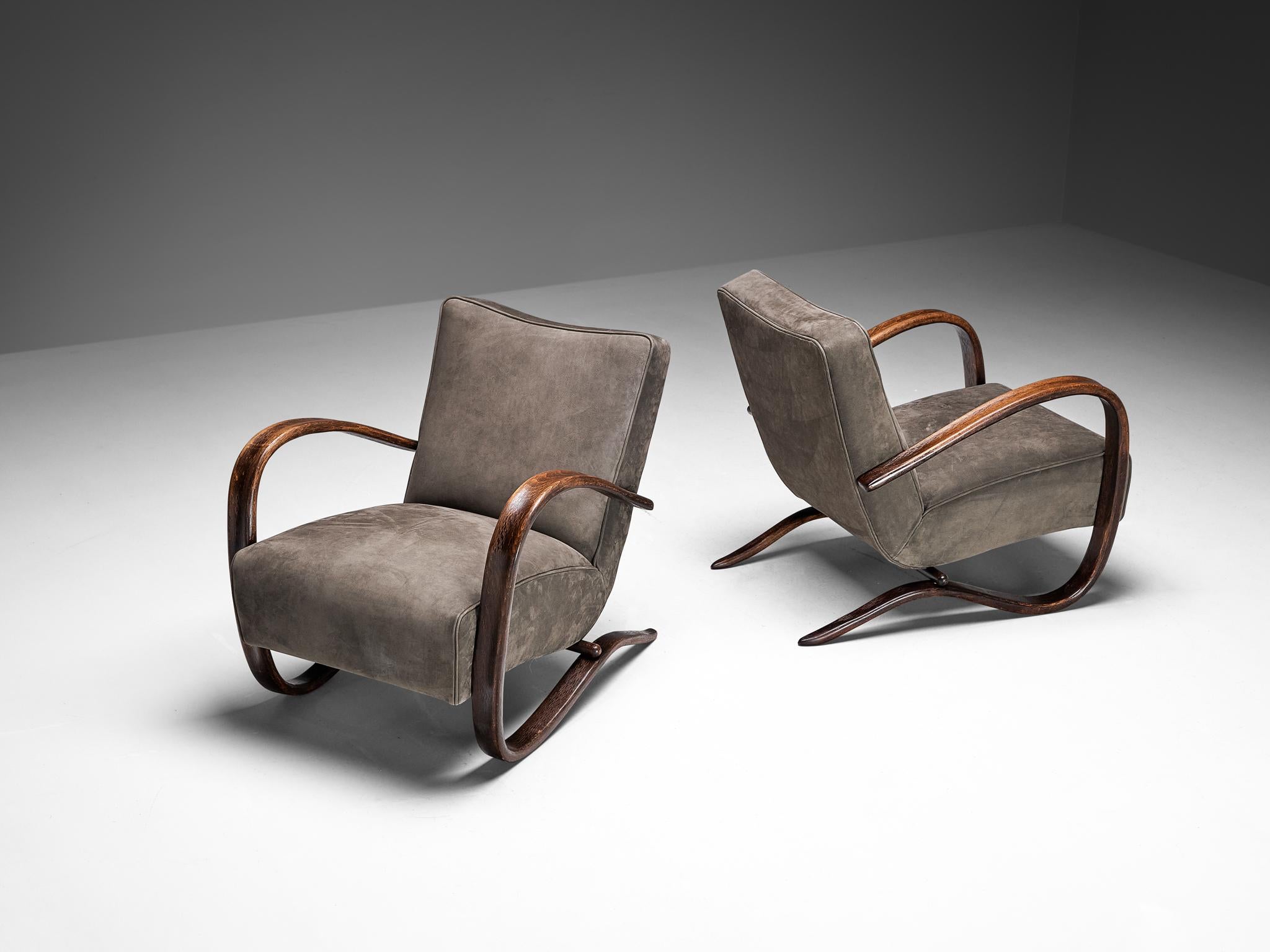 Jindrich Halabala, lounge chairs, model 'H269', nubuck leather, stained beech, Czech Republic, 1930s.

Extraordinary easy chairs upholstered in a durable nubuck leather in the color grey. These armchairs have a very dynamic and abundant appearance