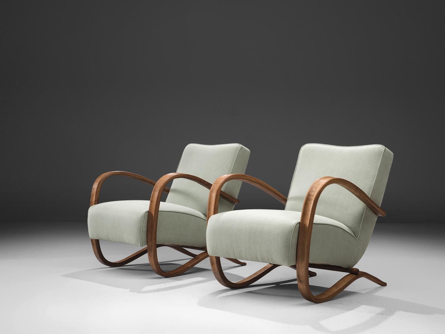 Jindrich Halabala, lounge chairs, model 'H269', stained beech, fabric, Czech Republic, 1930s.

Extraordinary easy chairs in mint green upholstery. These chairs have a very dynamic and abundant appearance and the pastel green upholstery gives them a