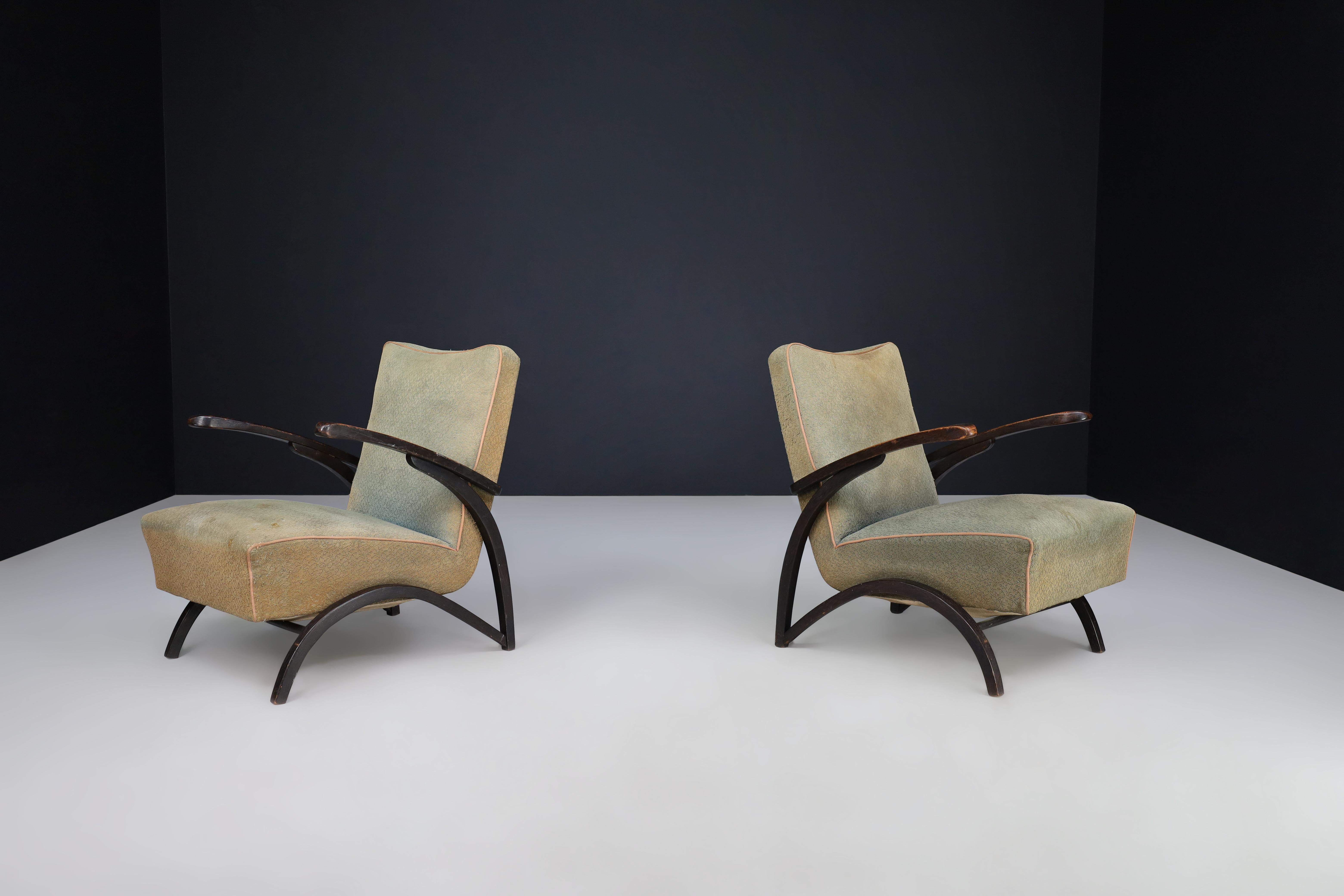 Jindrich Halabala Lounge Chairs in Original Upholstery Czech Republic 1930. 

These lounge chairs, designed by Jindrich Halabala and produced by Thonet in Czechia around 1930, are an exemplary representation of the midcentury design in Central