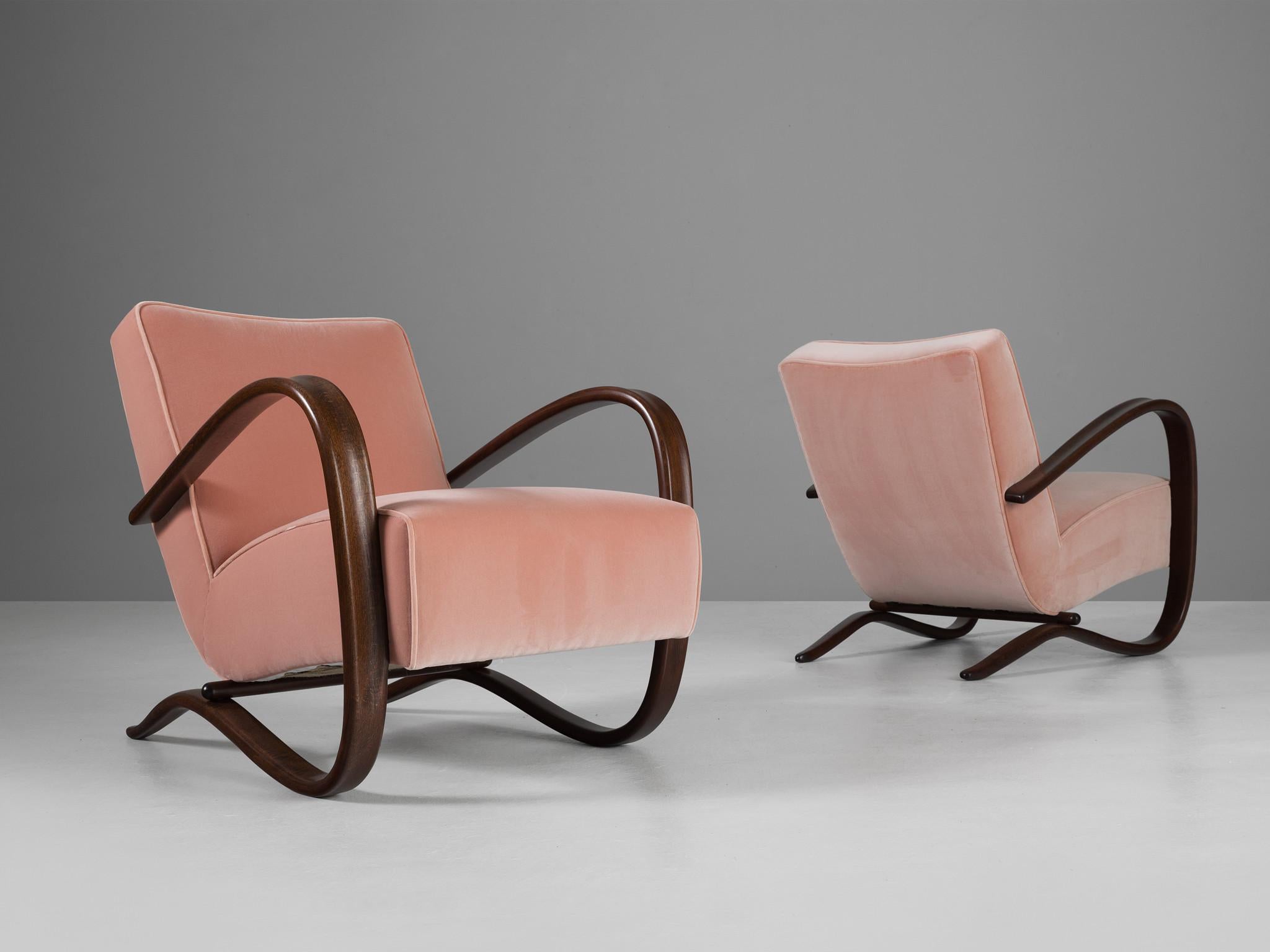 Jindrich Halabala, lounge chairs, model 'H269', stained beech, velvet, Czech Republic, 1930s.

Extraordinary easy chairs upholstered in a fine powdery pink velvet. These armchairs have a very dynamic and abundant appearance and the pink colored