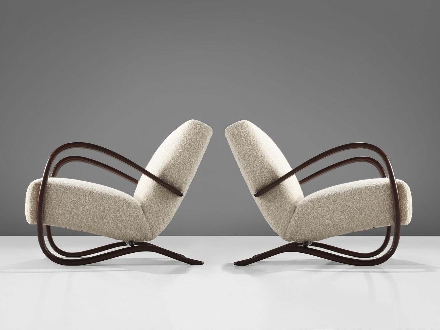 Jindrich Halabala, lounge chairs, model 'H269', stained beech, Pierre Frey bouclé, Czech Republic, 1930s.

Extraordinary easy chairs upholstered in a fine off-white bouclé by Pierre Frey. These armchairs have a very dynamic and abundant appearance