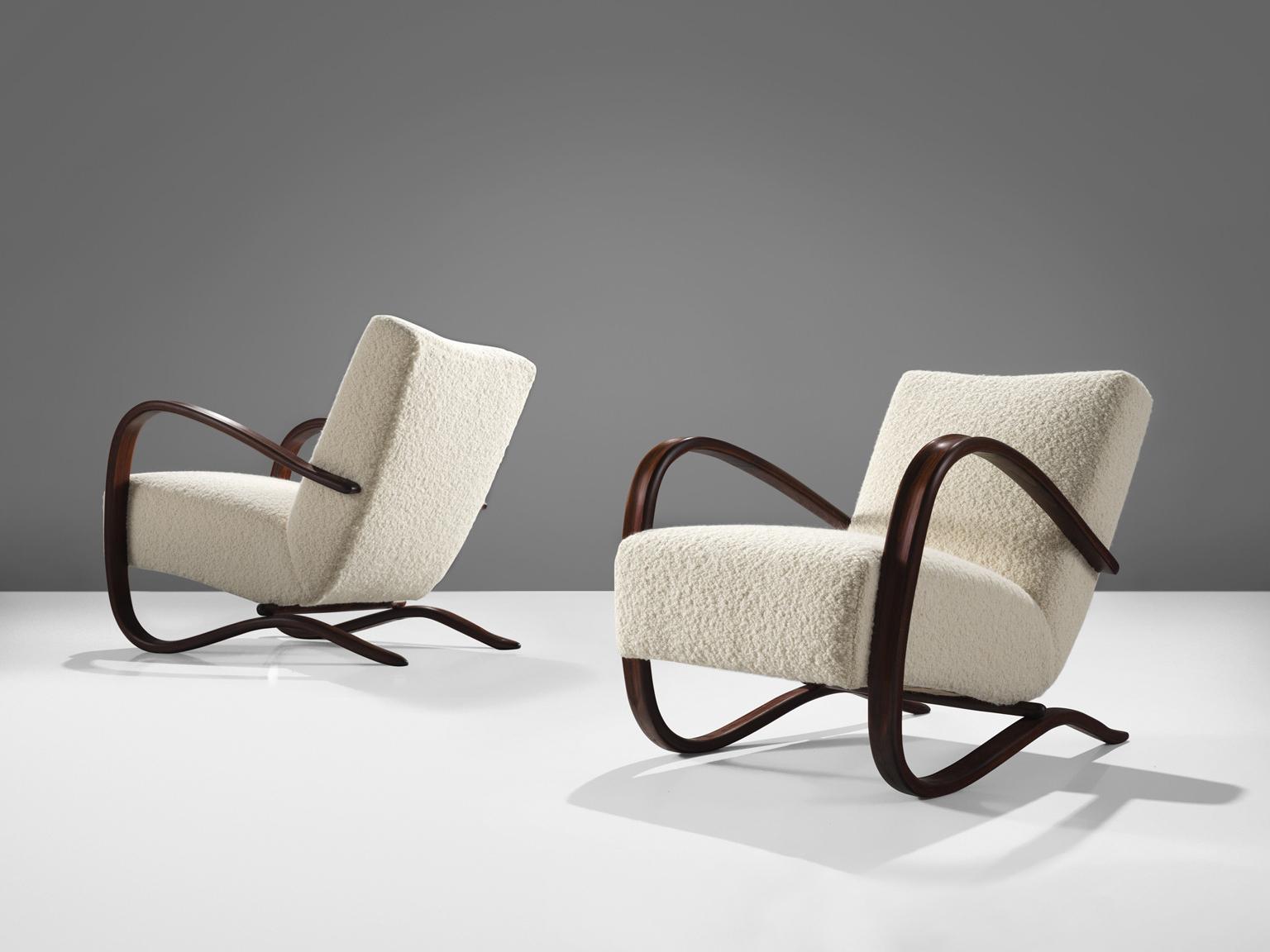 Jindrich Halabala, lounge chairs, model 'H269', stained beech, Pierre Frey bouclé, Czech Republic, 1930s.

Extraordinary easy chairs upholstered in a fine off-white bouclé by Pierre Frey. These armchairs have a very dynamic and abundant appearance