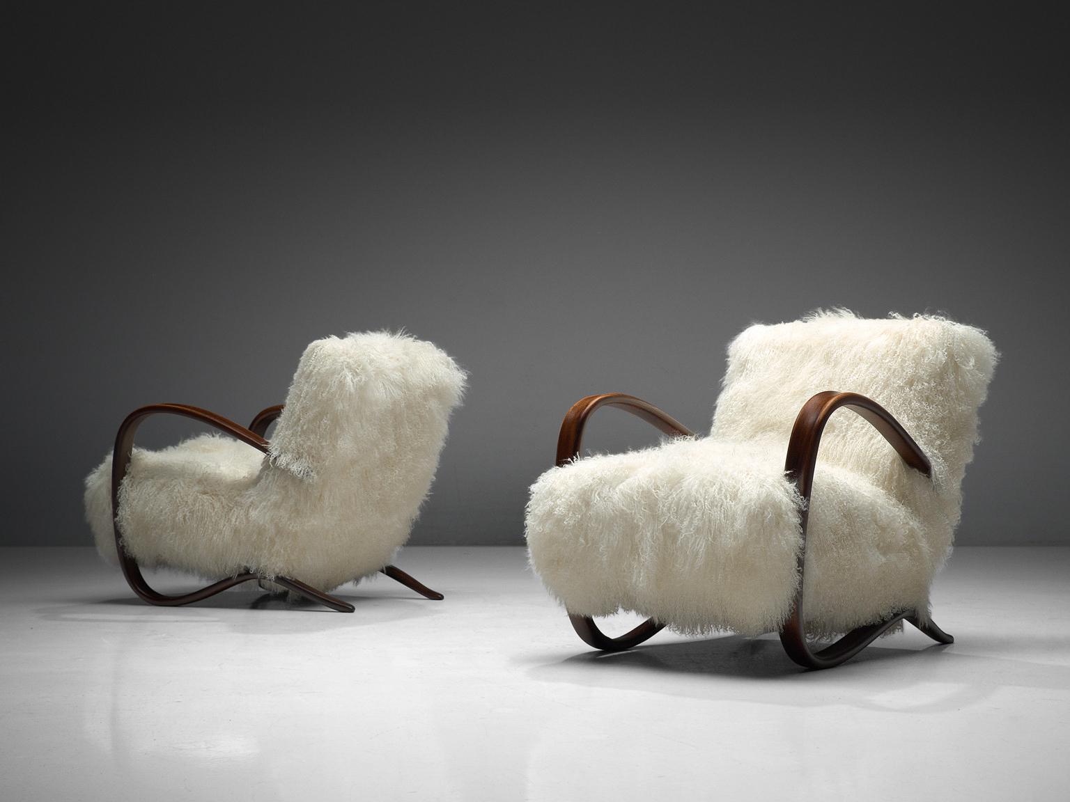 Jindrich Halabala, lounge chairs model 'H269', in beech and sheepskin, Czech Republic, 1930s.

Extraordinary easy chairs with white Tibetan lambswool upholstery. These chairs have a very dynamic and abundant appearance and the fuzzy upholstery
