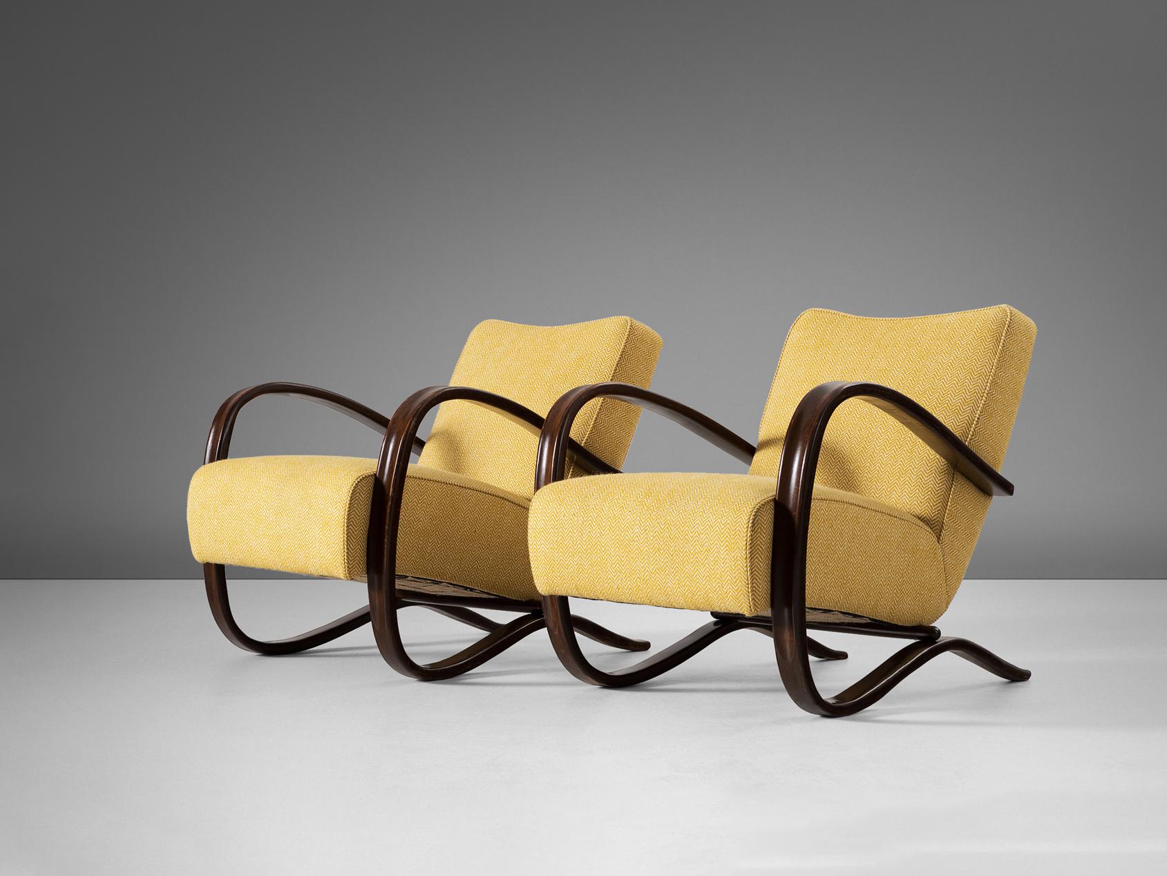 Jindrich Halabala, lounge chairs, model 'H269', stained beech, fabric, Czech Republic, 1930s.

Extraordinary easy chairs in yellow upholstery. These chairs have a very dynamic and abundant appearance and the color of the upholstery gives them a