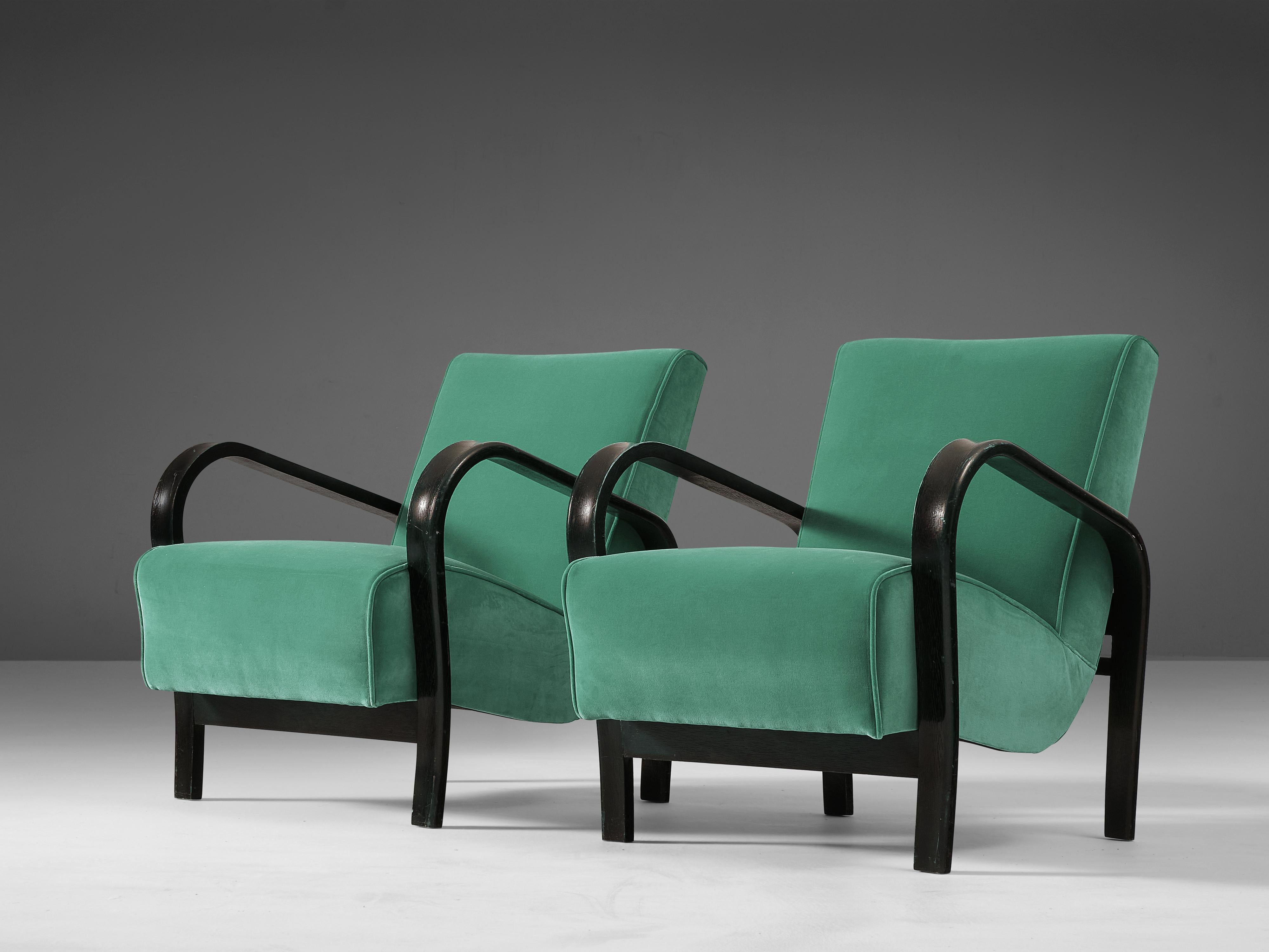 Jindrich Halabala, armchairs, wood, fabric, Czech Republic, 1930s.

Dynamic armchairs with beautiful fluent armrests. The main feature of these chairs are the voluptuous curved armrests that are so typical for Halabala. Thanks to these bended