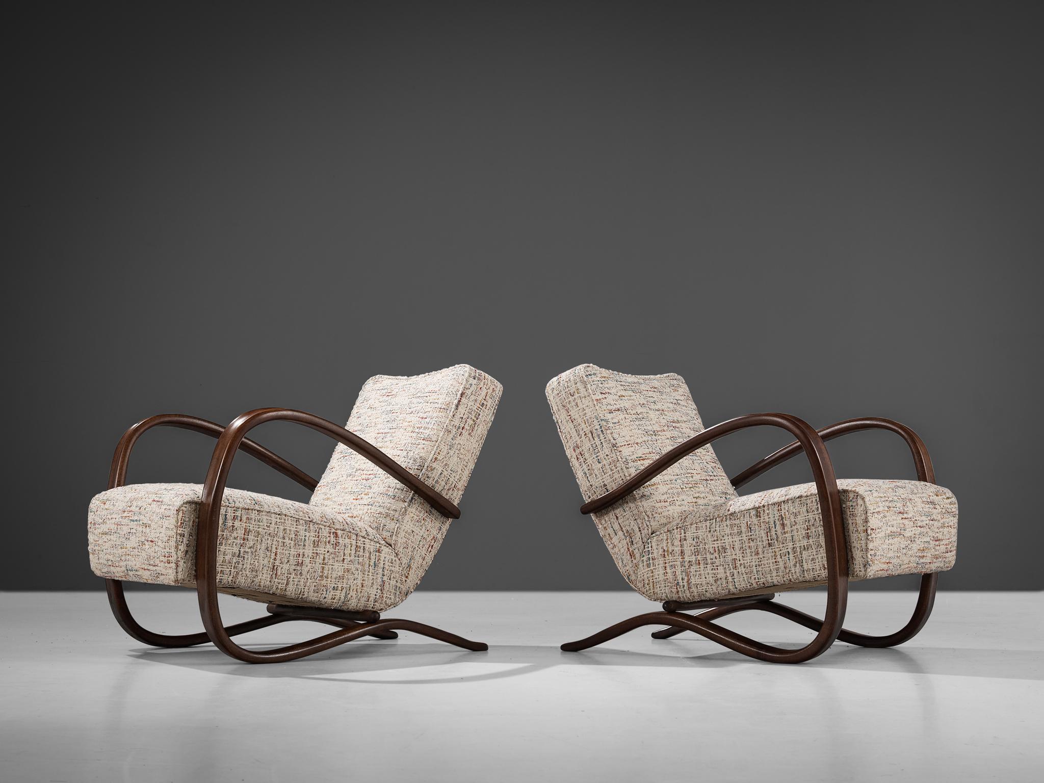 Jindrich Halabala, lounge chairs, in beech and fabric, Czech Republic, 1930s. 

Extraordinary pair of easy chairs in off-white with different color shades patterned fabric upholstery. These chairs have a very dynamic appearance that, for instance,