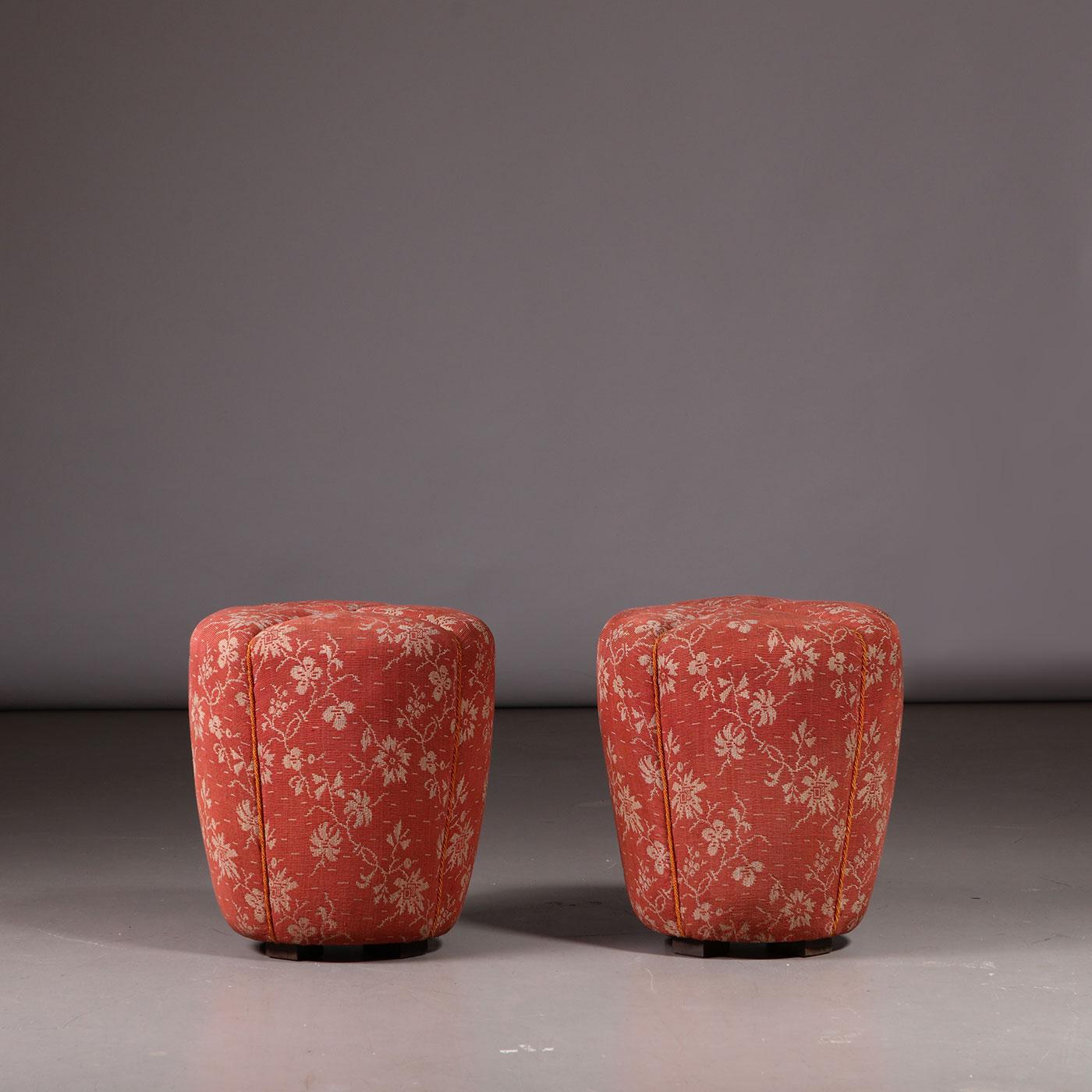 Pair of stools, tabourets, ottomans, designed by Jindřich Halabala. Produced by Spojené UP Závody in the 1930s. Wooden legs, original coral floral upholstery.

Designed by Jindřich Halabala (1903–1978) and manufactured by Spojené UP závody in the