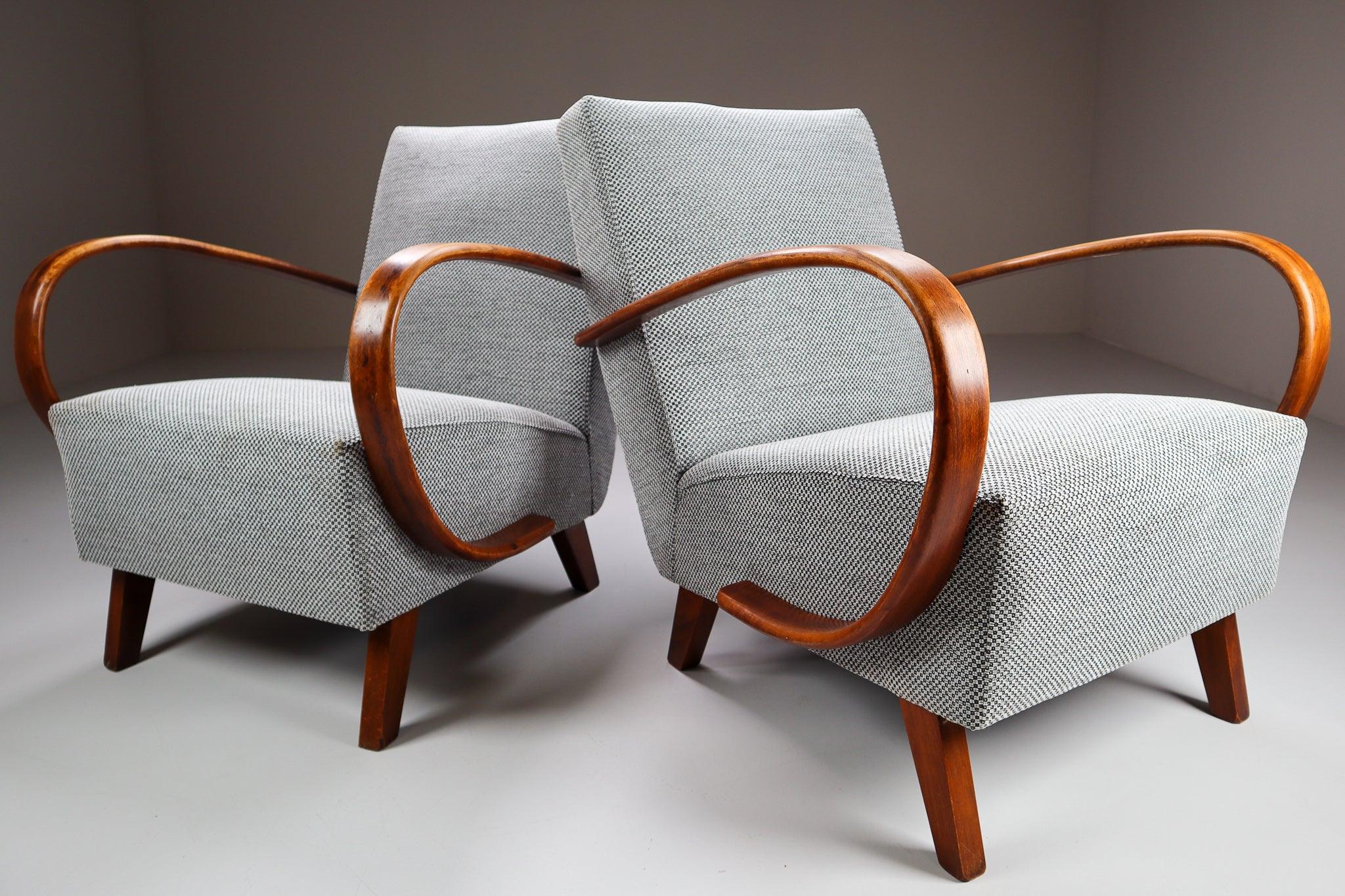 These iconic set chairs hail from Czechia, circa 1940. Produced by Thonet, these chairs (model H-227) designed by Jindrich Halabala, are a benchmark for midcentury design in Central Europe. A simple and elegant geometry contrasts the soft and