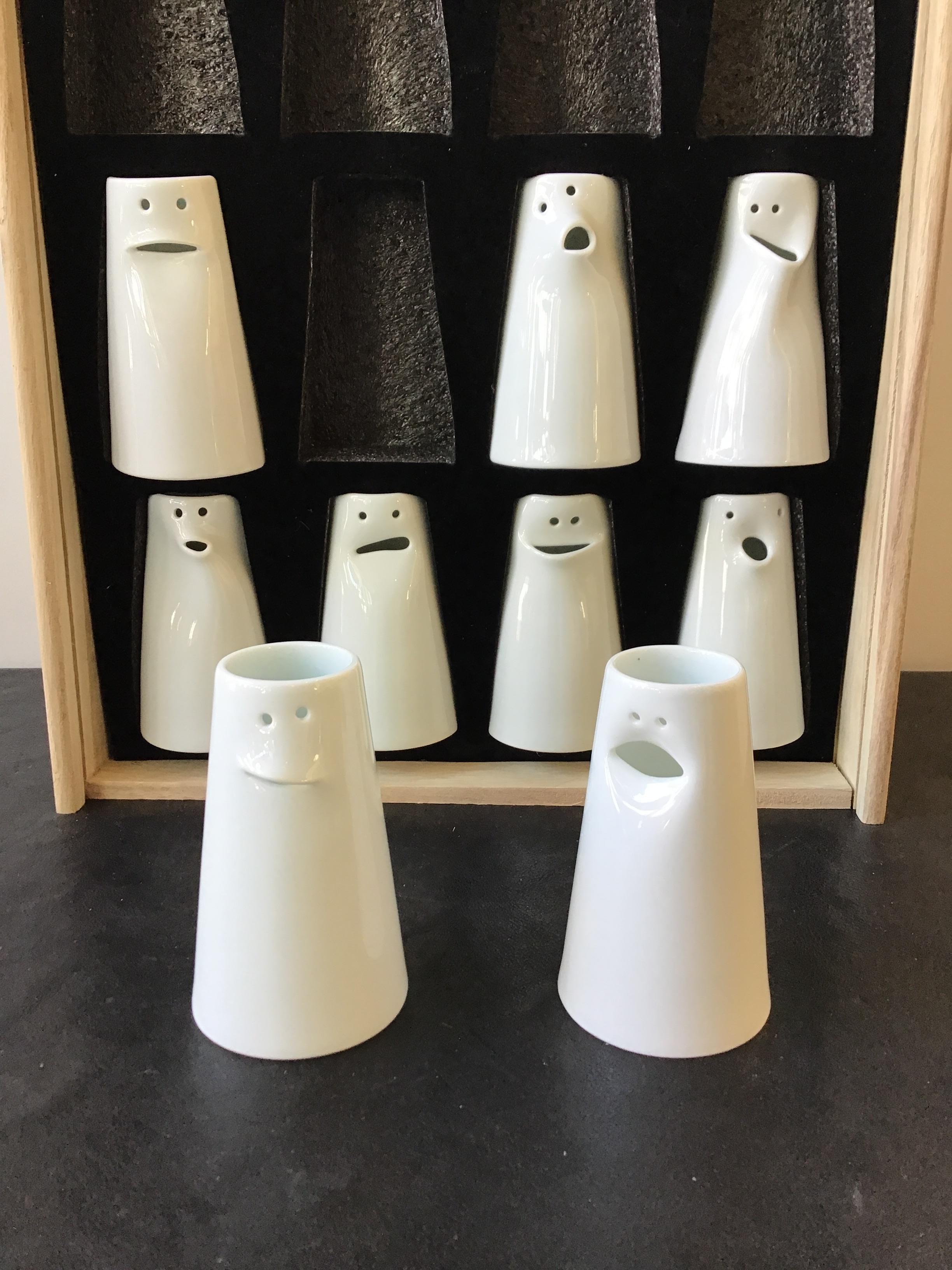 Unique expressive fine porcelain face bud vases, designed by Tong Wei. Made by Jingdezhen for Spin Ceramics. Some can be used as a creamer. Each face different, set of 9.