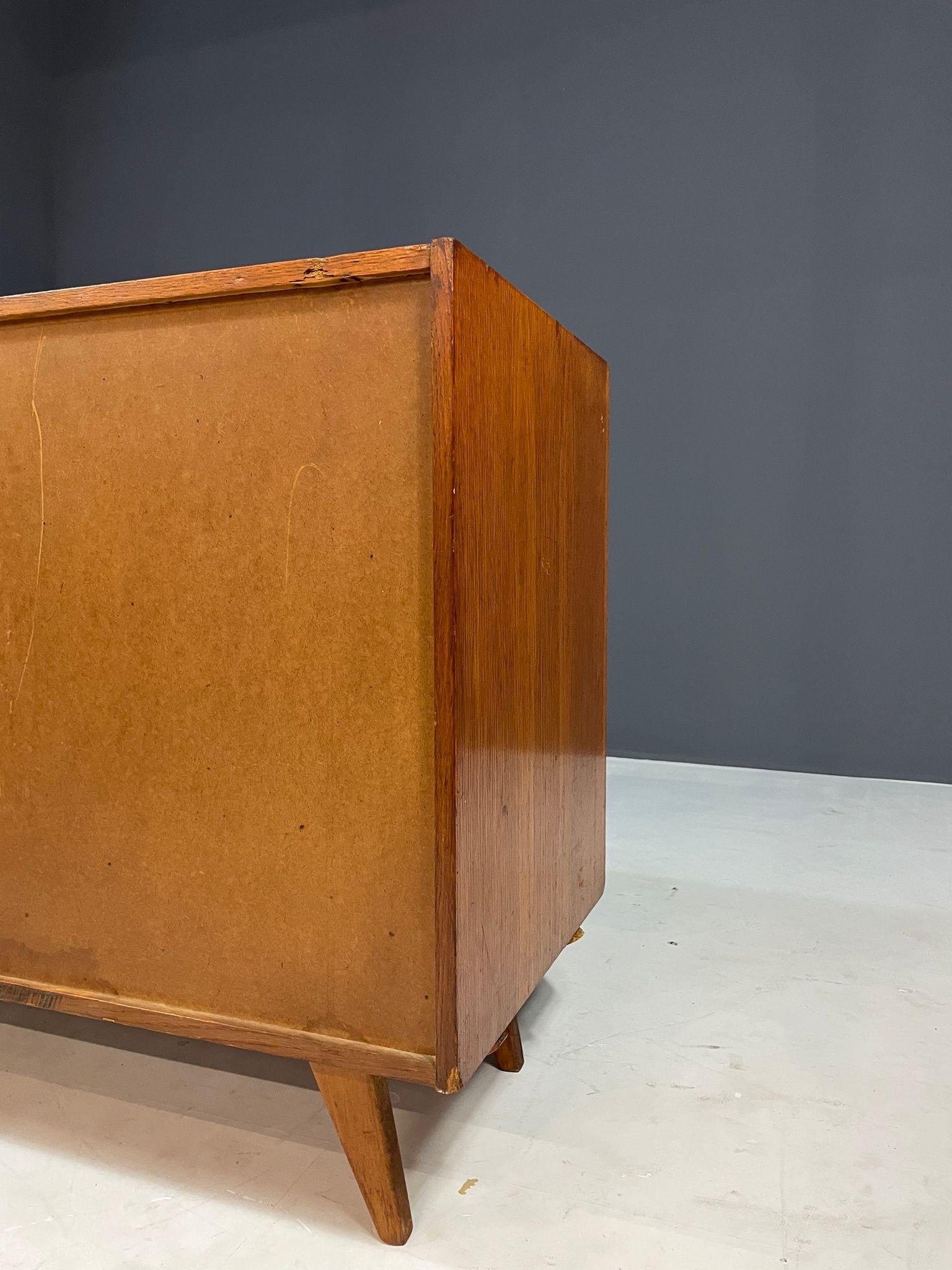 Iconic model U-452 chest of drawers designed by Jiří Jiroutek for Interiér Praha in Czechoslovakia during the 1960s. This celebrated piece features sculptural drawer fronts in grey, white, black, and yellow, set within a veneered wood case on