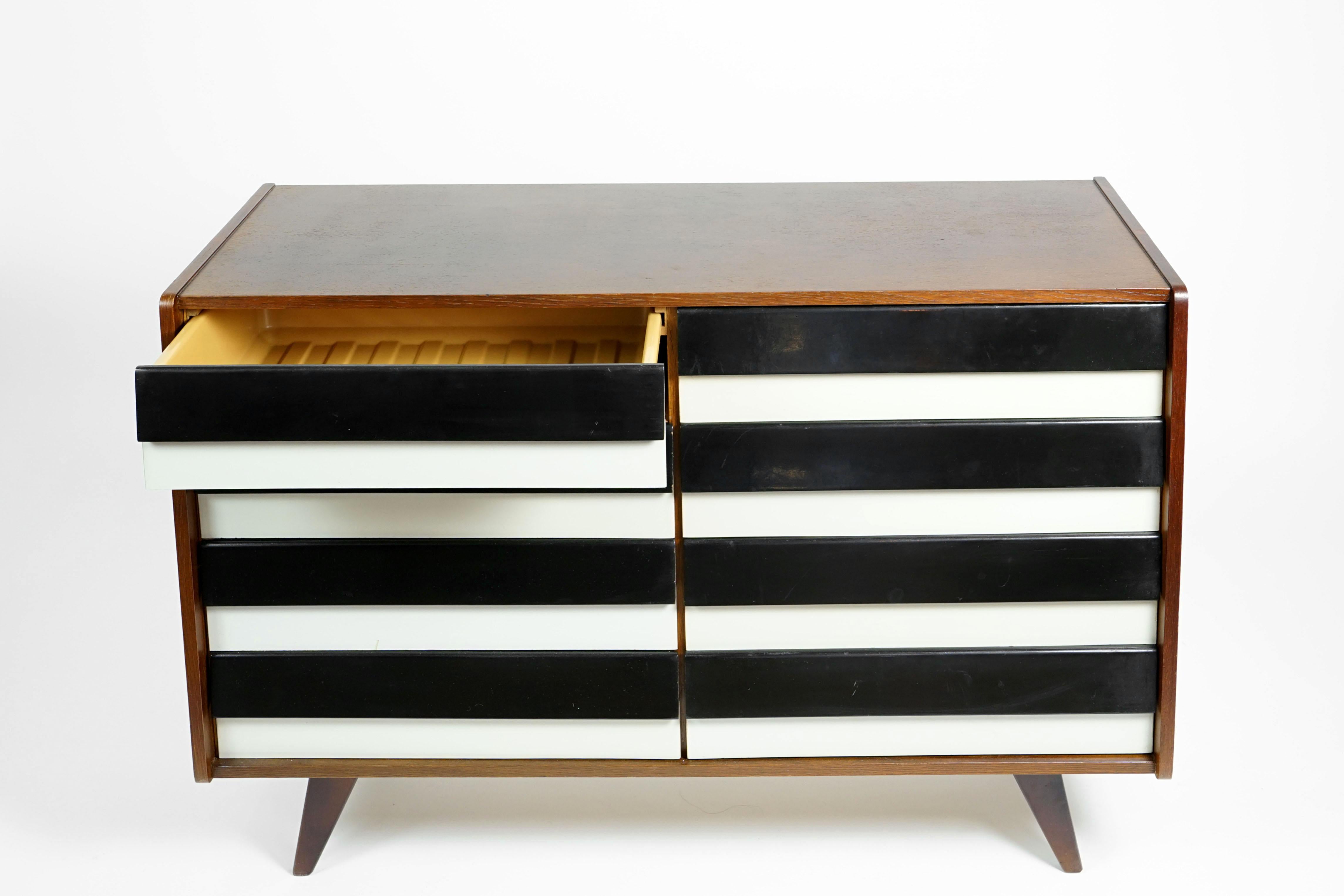 Midcentury sideboard with black and white drawers.
Designed by Czech furniture and interior designer Jiri Jiroutek in the 1960s for Interieur Praha.
Drawers are made of plastic. The wood is completely restored.
 