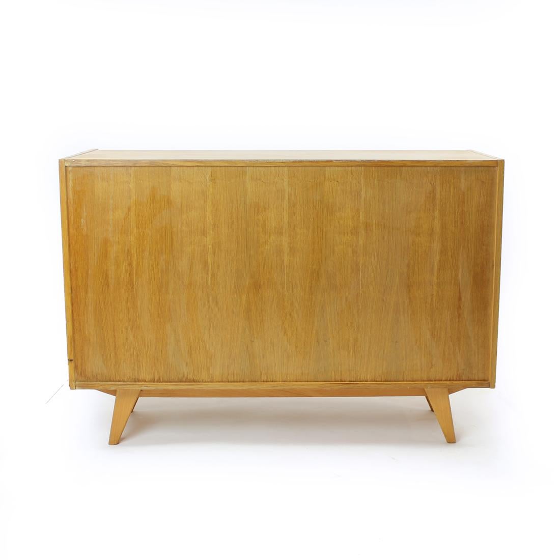 Beautiful sideboard with sliding doors produced in 1960s, in the midcentury design era of Czechoslovakian design. Designed by Jiri Jiroutek for Interier Praha. The sideboard is completely done in veneered wood with a beautiful oak veneer. Partially