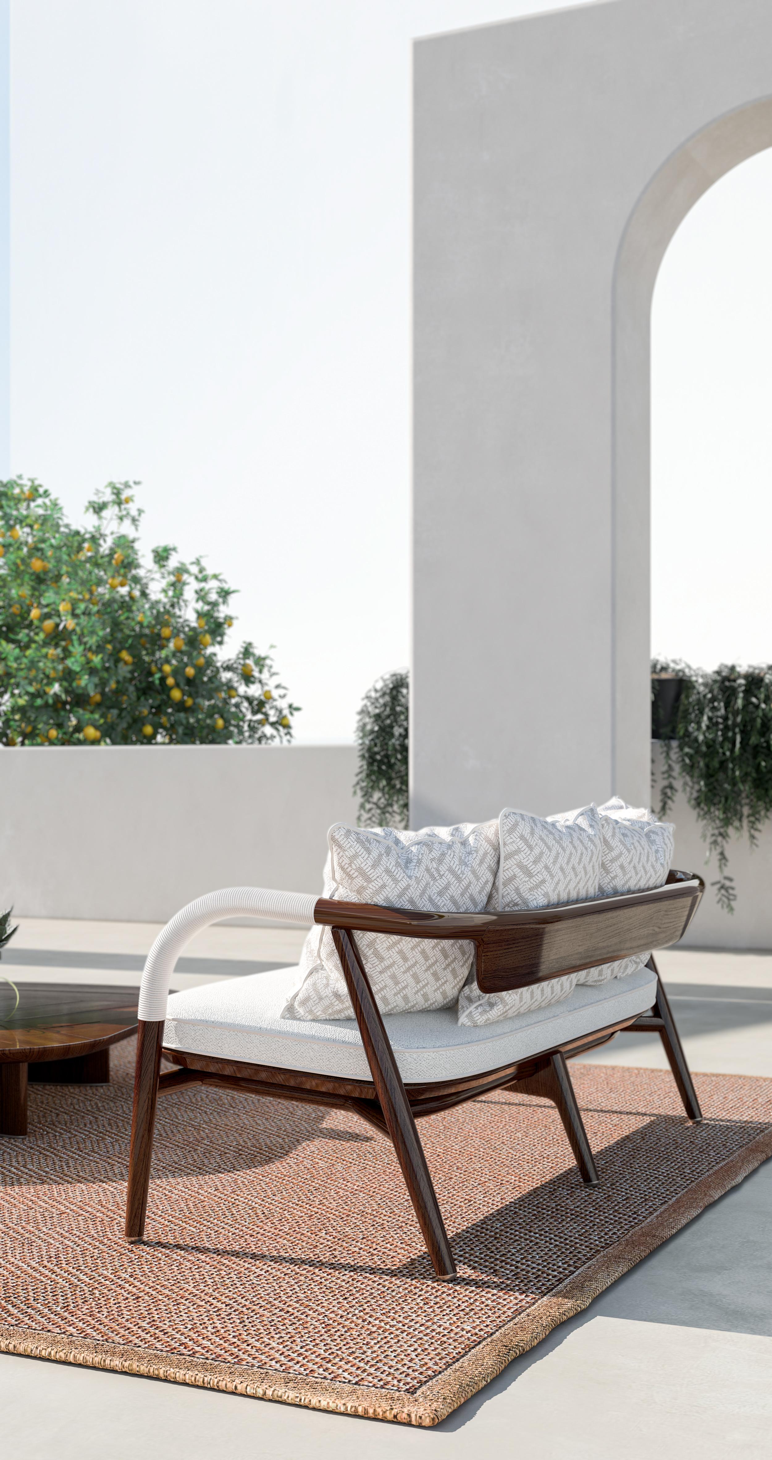 An outdoor love seat with a wooden frame, fabric upholstery, and leather-covered armrests combines both elegance and comfort. The sturdy frame is crafted from high-quality wood, providing a solid and durable foundation. The seating area is