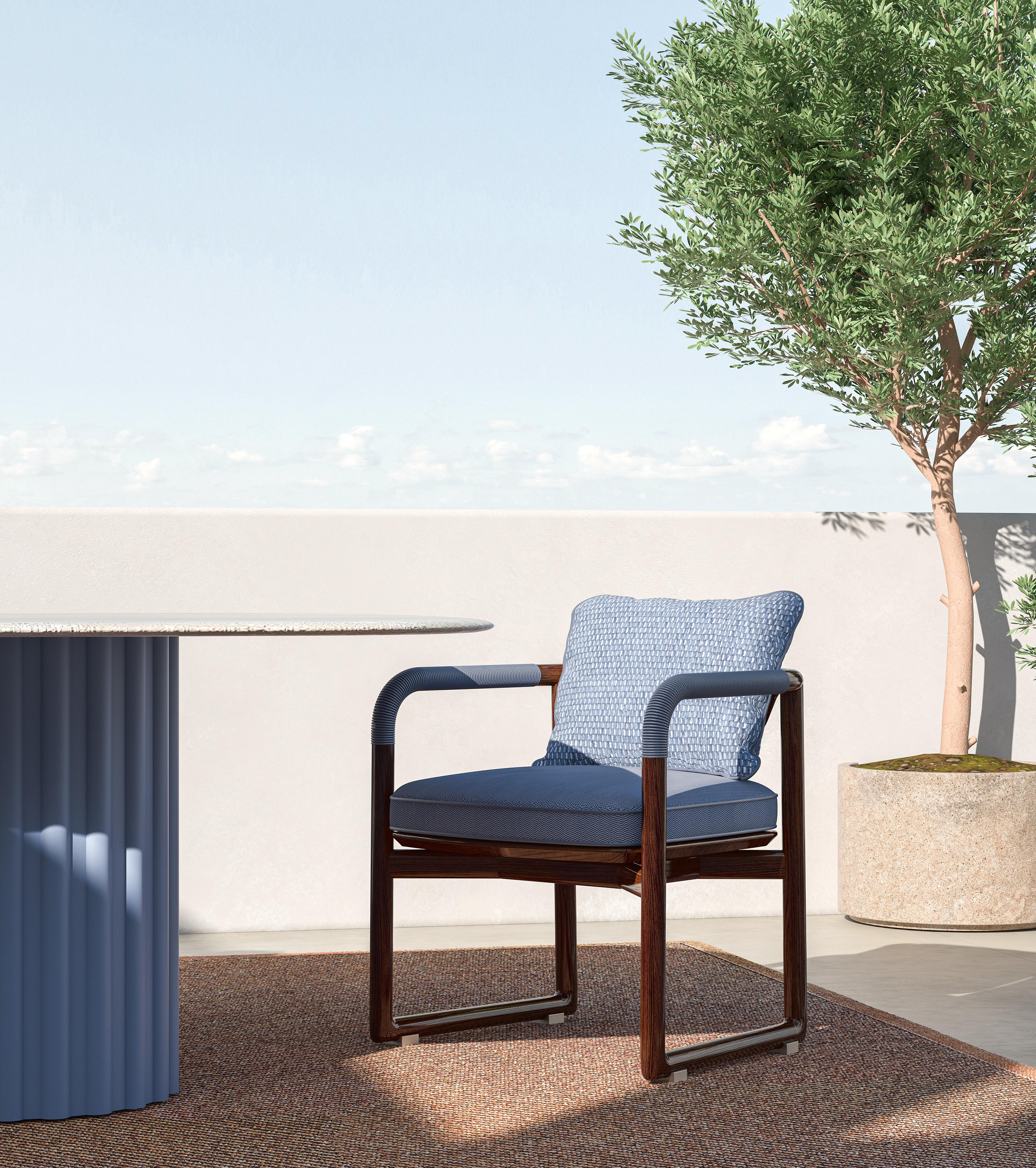 An elegant outdoor chair with a glossy mahogany frame that adds a touch of sophistication to any setting. The chair features a comfortable fabric upholstery, designed for durability and style in outdoor environments. The armrests are tastefully