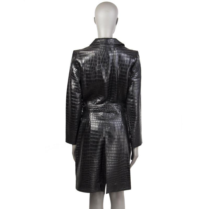 Jitrois coat in black crocodile. With notch collar, belt loops and back slit. Closes with crocodile-lined buttons on the front. Lined in black fabric. Comes with belt strap in black crocodile. Has been worn and is in excellent condition. 

Tag Size
